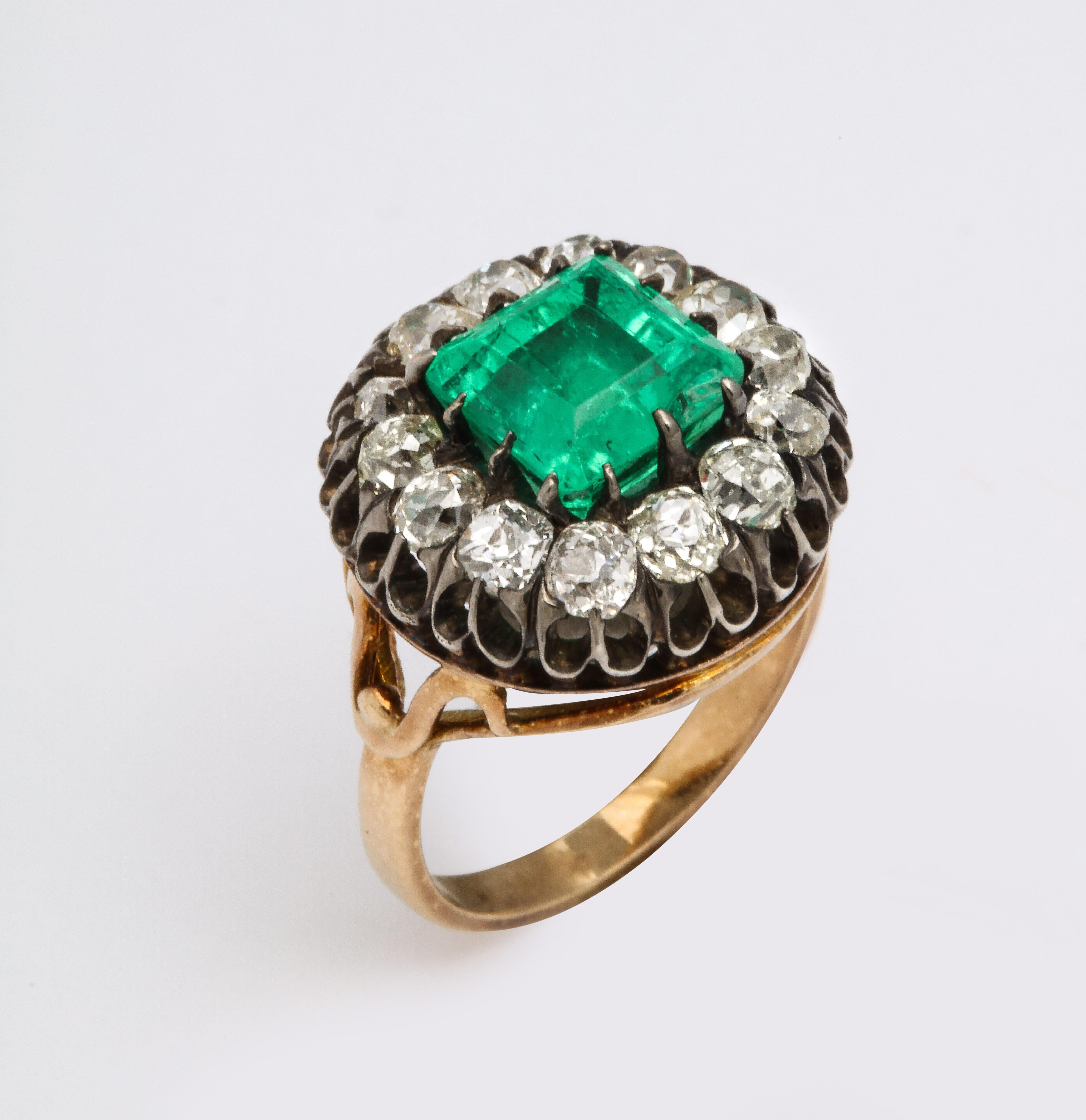 This Antique Square Cut Emerald and Old Mine Diamond ring is a rare find.  The Colombian Emerald is surrounded by fine old mine cut diamonds set in yellow and white 18K gold. 
iIt is elegant and charming and looks great on the hand.  GIA certificate