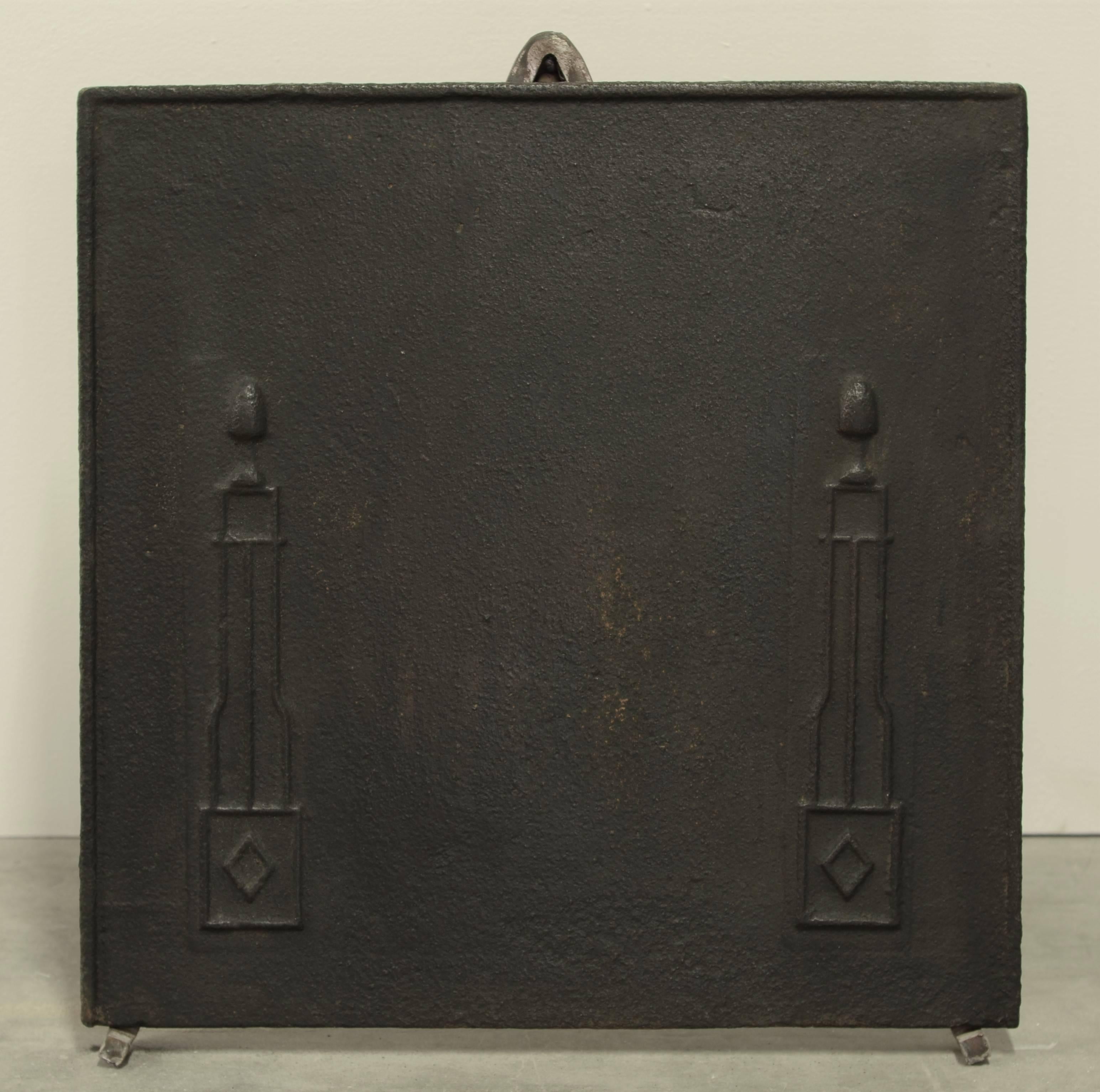 Decorative and small antique cast iron fireback.

Great usable size and excellent condition. 
To be used in a fireplace or as a backsplash.
Can be supplied with stand.