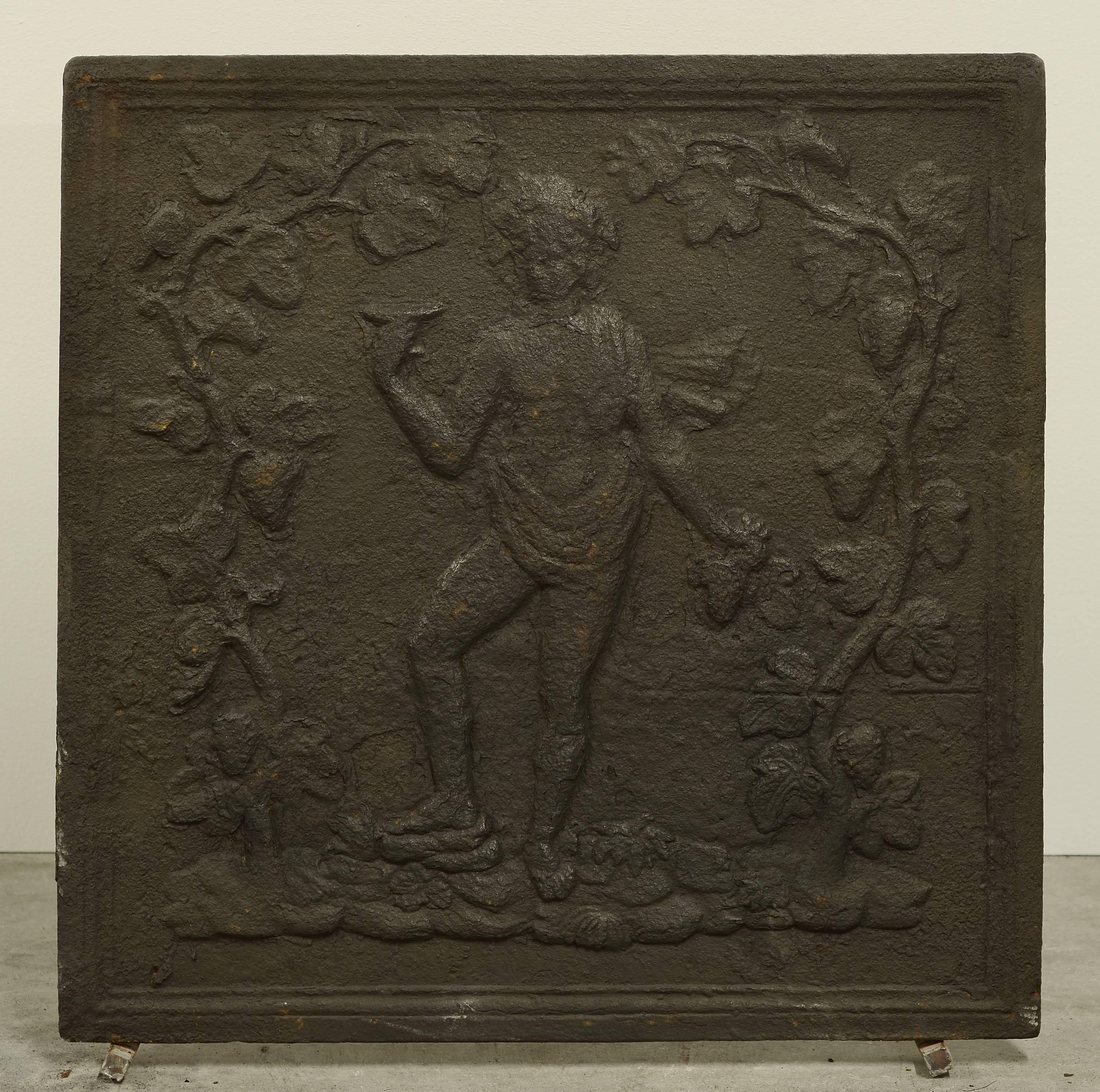 Great square antique cast iron fireback showing a female drinking.

Excellent condition, great dimension.
Can be used in a fireplace or as backsplash.