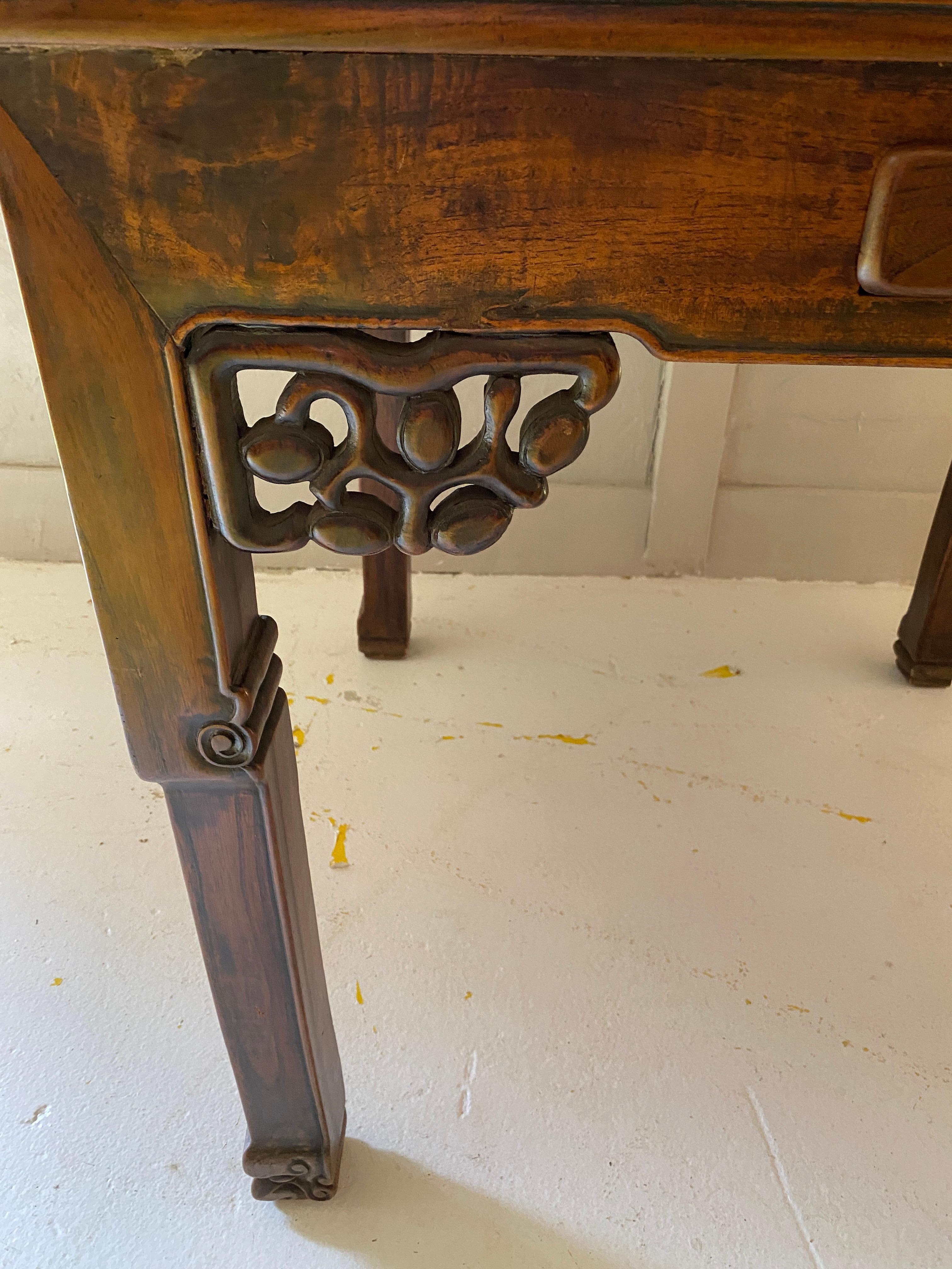 This antique Square Mahjong table has 2 small drawers on each side for tile or small object storage. The table has wood carved design and wood carvings down the legs.