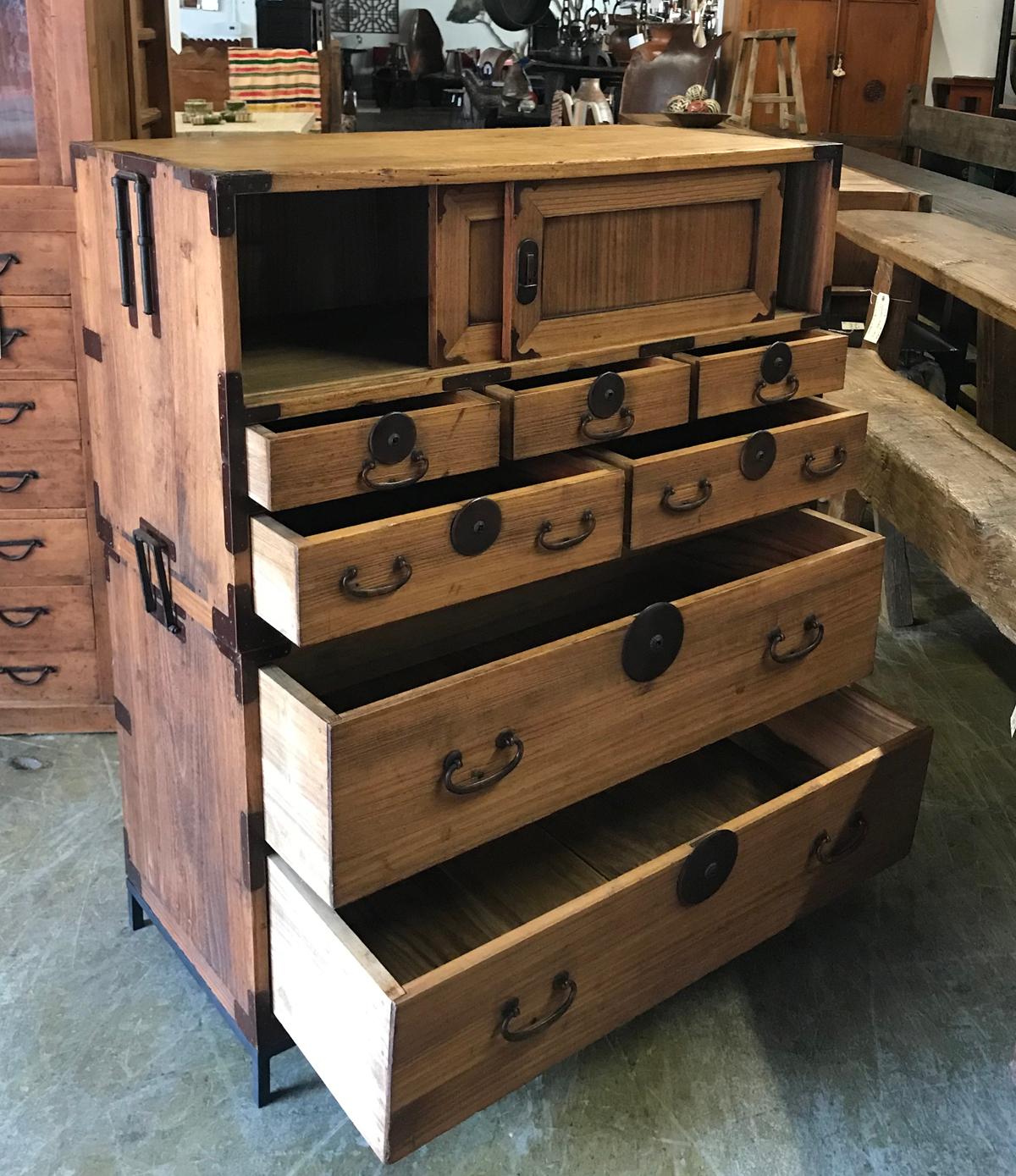 Japanese stacked tansu on custom made metal stands. Bottom pieces has two drawers and the top has a pair of sliding doors and five smaller drawers. In excellent condition and abundance of storage. Medium light color with smooth patina. Sturdy and