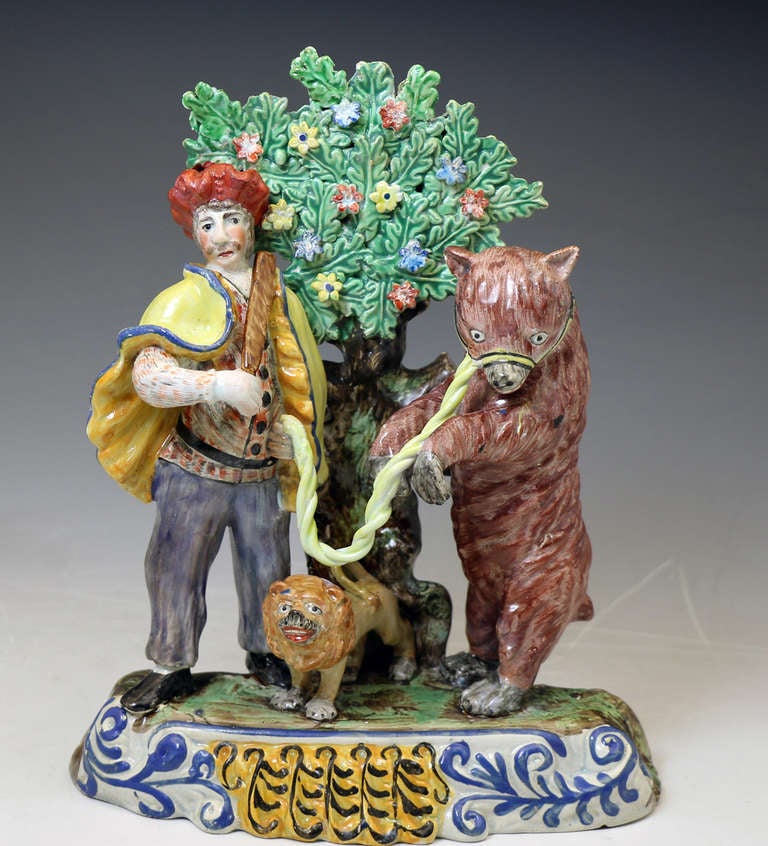 Antique Staffordshire pottery pearl ware bocage figure of a Dancing Bear group with bocage, circa 1820.
This highly decorative figure group comprises the bear, troubadour and a rather charming lion.

Dimensions: 7.00 inch wide, 9.00 inch high,