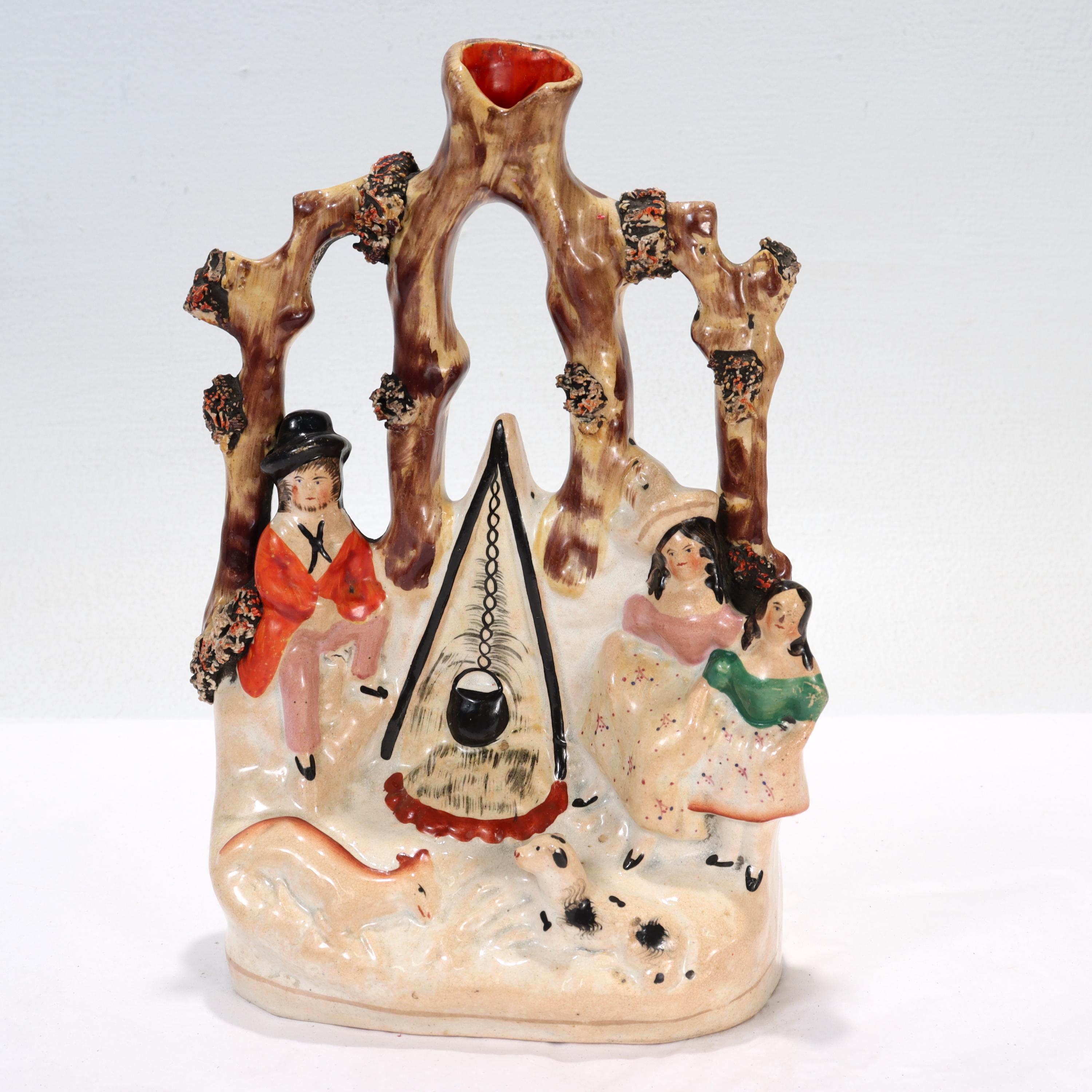 A fine antique Staffordshire pottery figural flat back spill vase.

In the form of a gypsy family with livestock gathered around a cooking fire in a forest.

Simply a rare and wonderful Staffordshire pottery figurine! 

Date:
19th Century

Overall