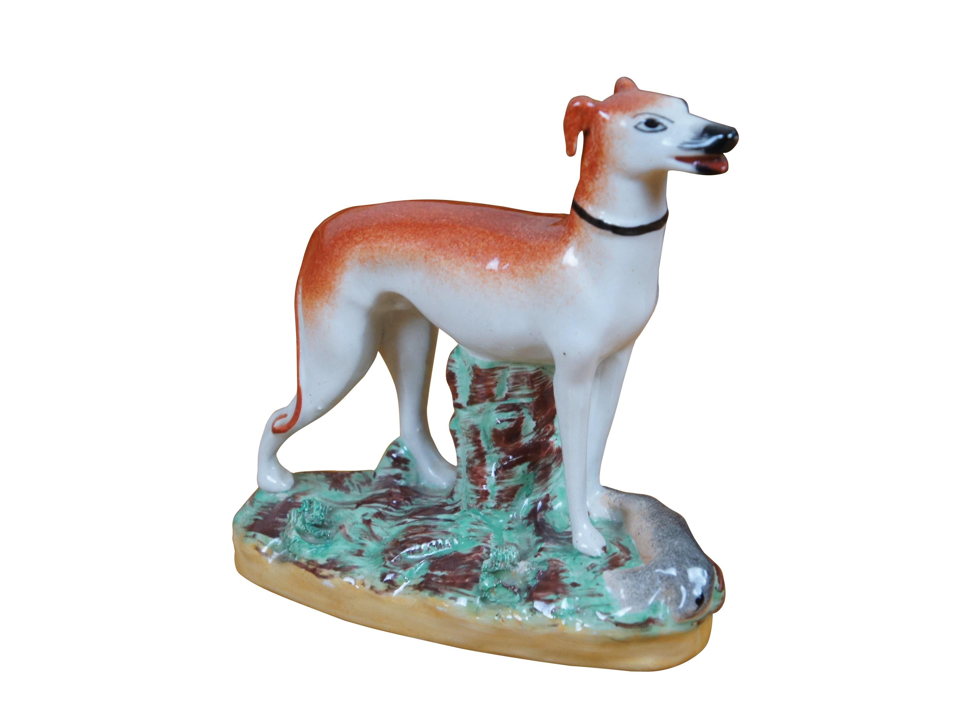 Antique 19th century English Staffordshire porcelain game figurine in the shape of a red and white whippet / greyhound / hunting dog with a dead rabbit at its feet.

Dimensions
7