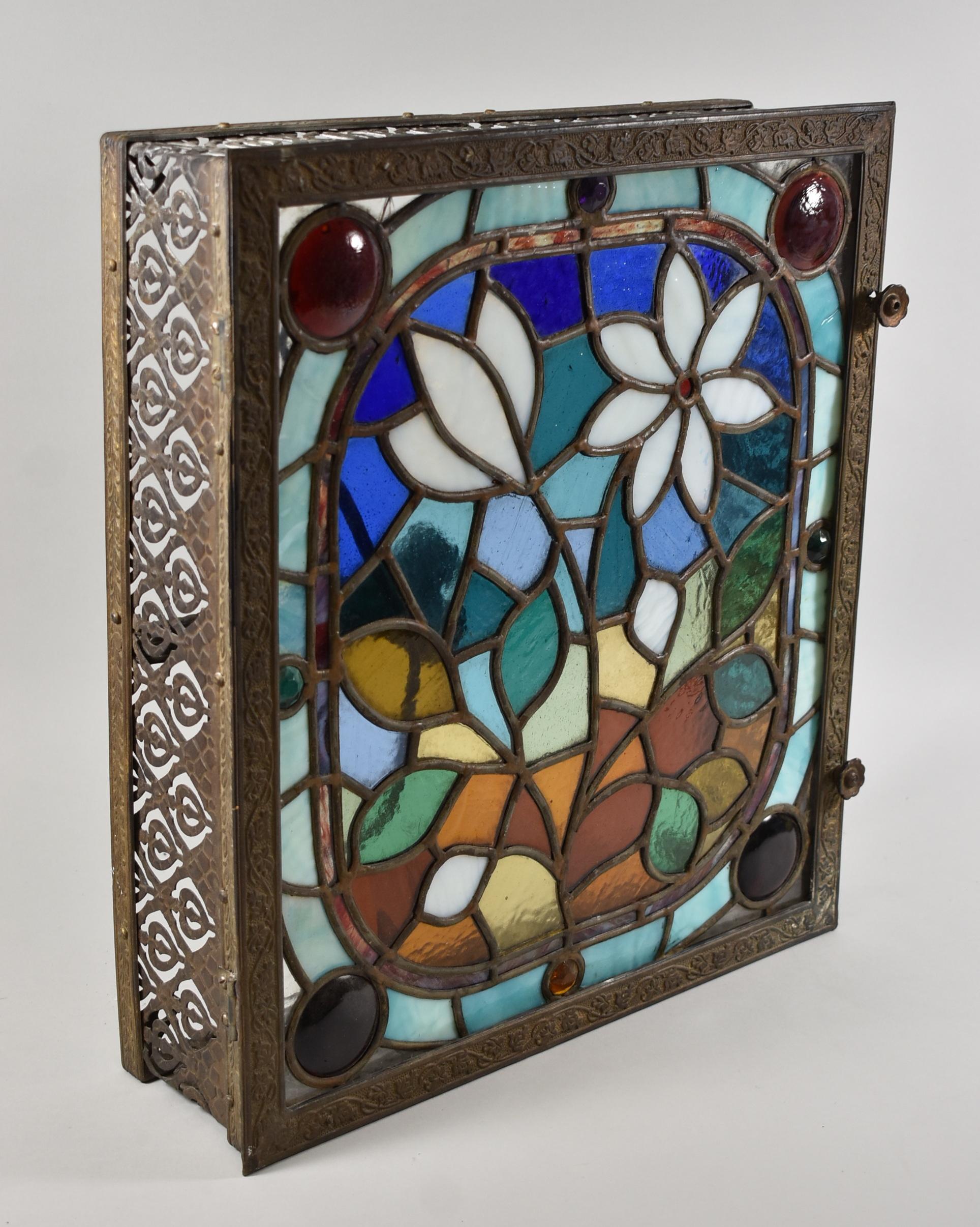 Antique stained glass ceiling light or wall stained glass panel. Faceted jewels and rondels. Brass frame is hinged for access. One socket. One small corner crack. Measures: 4.25