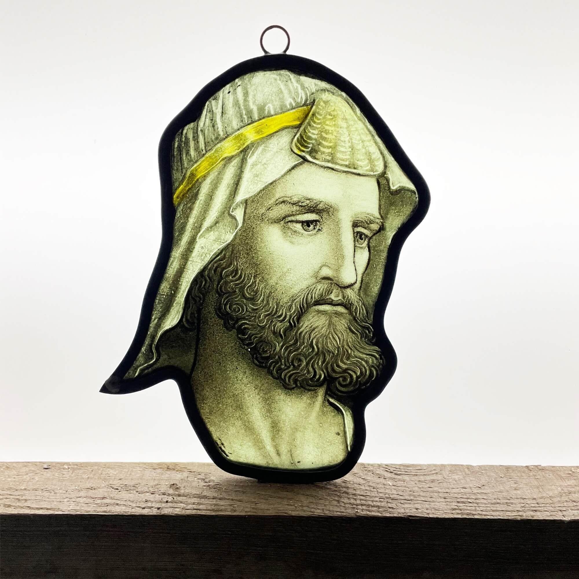 An antique stained glass panel depicting the face of a nobleman’s head dating to circa 1850. This contemplating figure is well painted in muted colours. At over 150 years old, the stained glass has stood the test of time; his beard, eyes, the