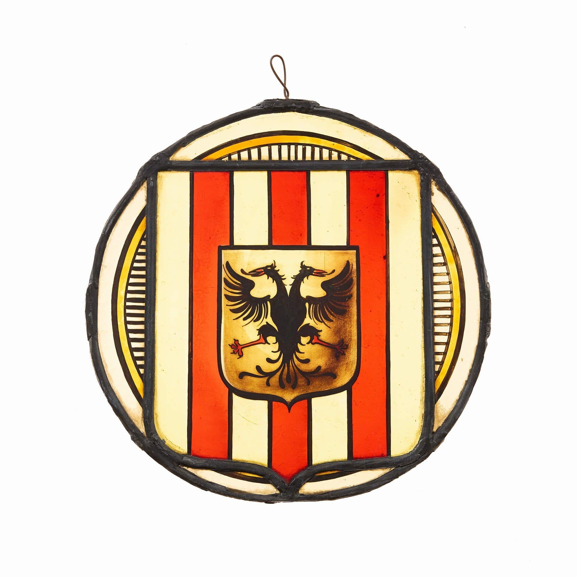An antique suncatcher stained glass panel depicting a stylised eagle design.

Handpainted with a stylised double headed eagle, this German stained glass is over 120 years old having stood the test of time.

Vibrant and bright colours highlight the