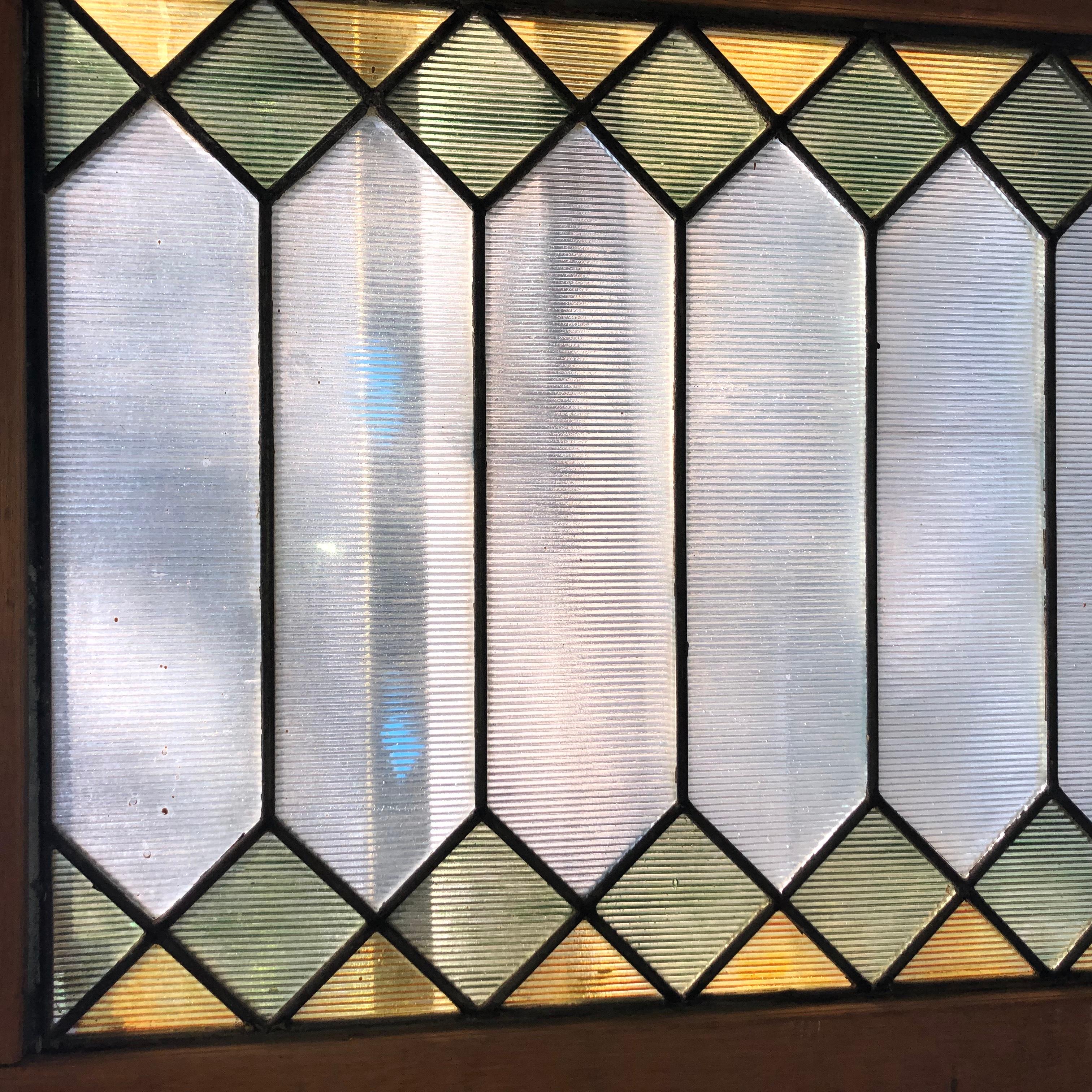 Finestra a traforo in vetro antico con vetri colorati a disegni geometrici. Lungo oltre un metro e mezzo, il vetro testurizzato ti garantirà privacy e luce solare!
Attualmente è alloggiato in una cornice di legno - le dimensioni complessive si