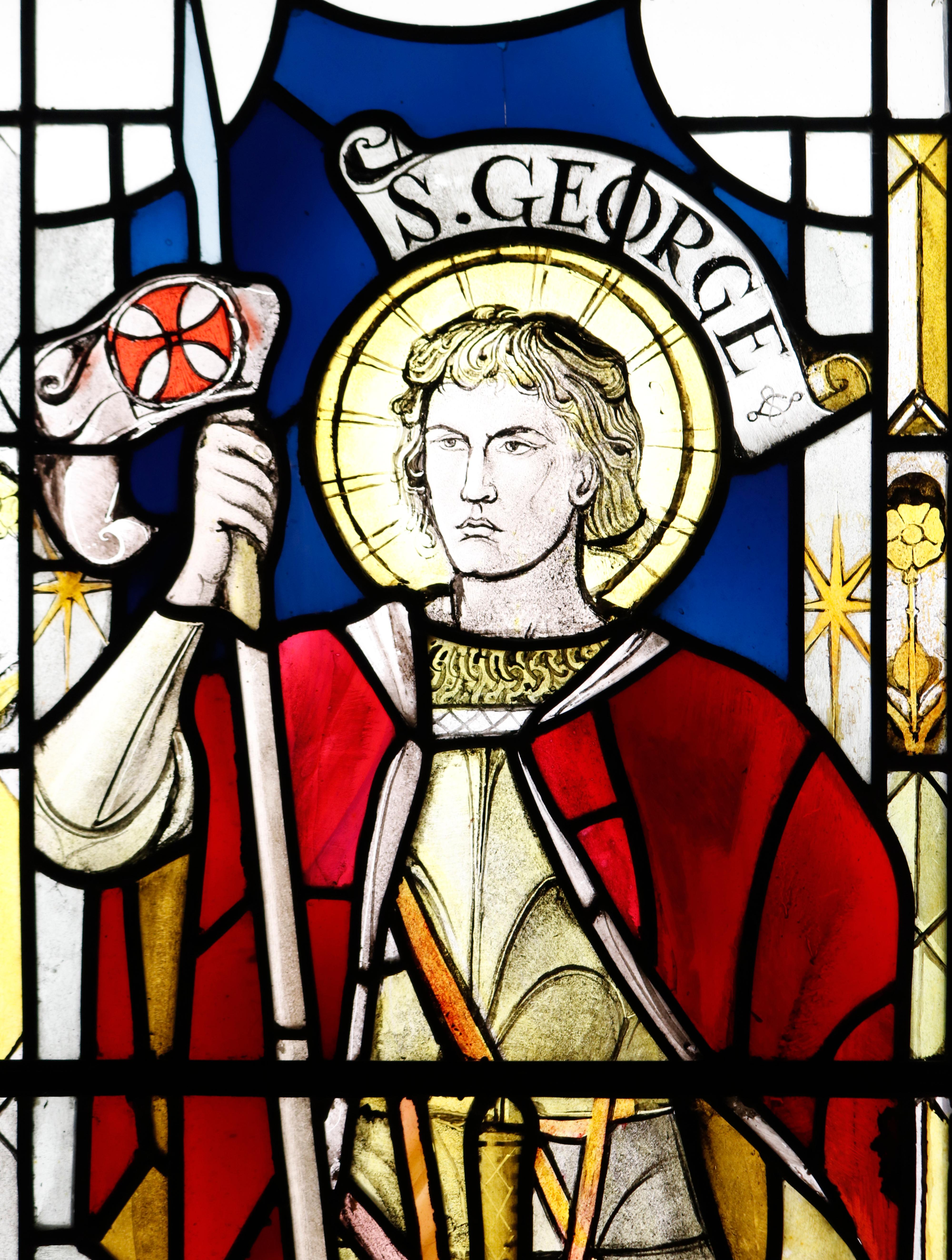 Antique stained glass window of St George.
An original and unrestored stained glass window or panel depicting St George. Dressed in armour, he can be seen equipped with a sword and shield. St George was made famous by his slaying of a dragon on the