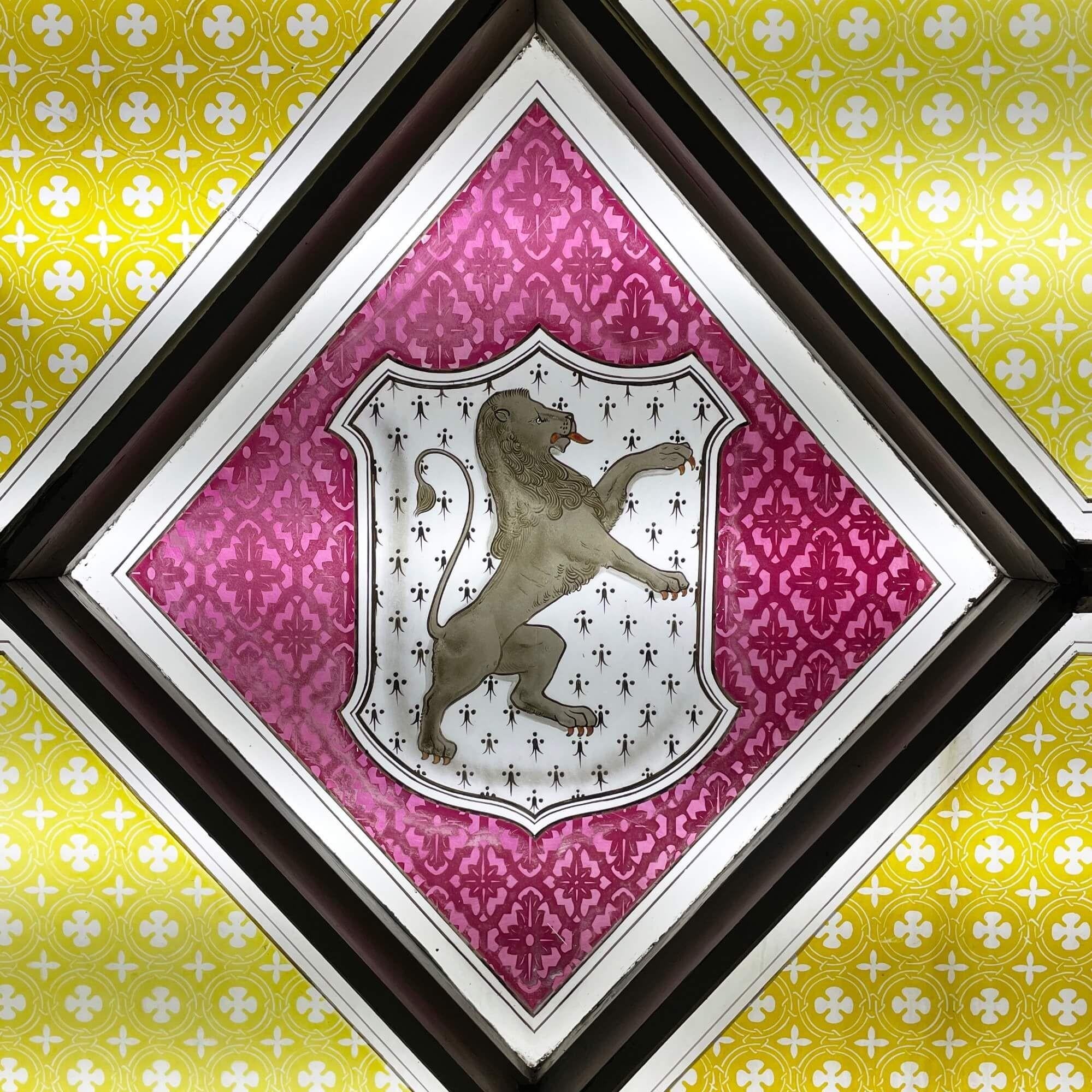 A large antique stained glass window detailed with the armorial crest of the Welsh family of Tudor Trefor, one of a series of 3 we are selling in the same style. At more than a metre square, this window is an impressive piece and features four