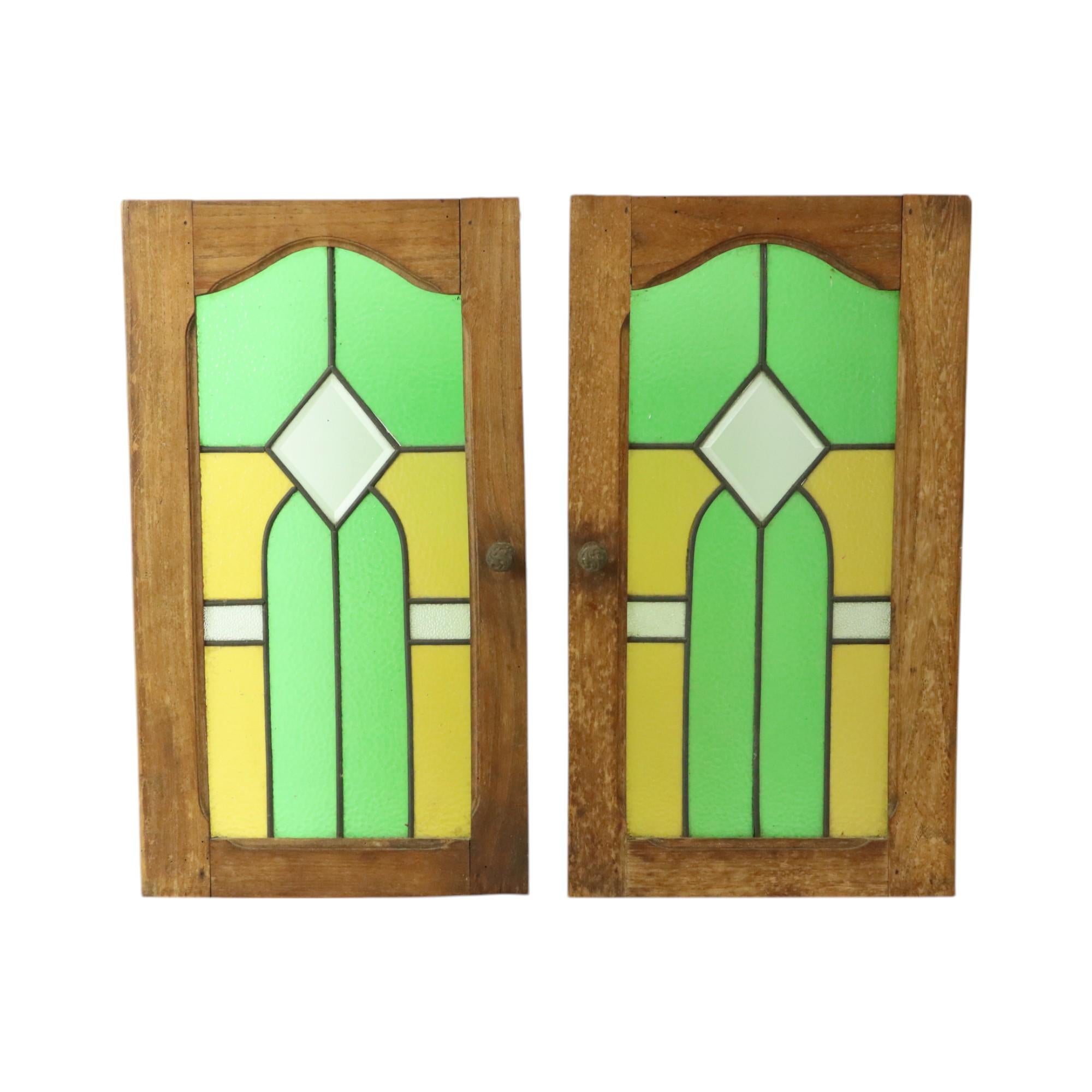 Beautiful antique stained glass windows, stained glass windows in an oak door panel, early 1900s, Belgium.

Beautiful bright colors and geometric shapes, typical art deco style, very nice and decorative to use as a light catcher.

In very good