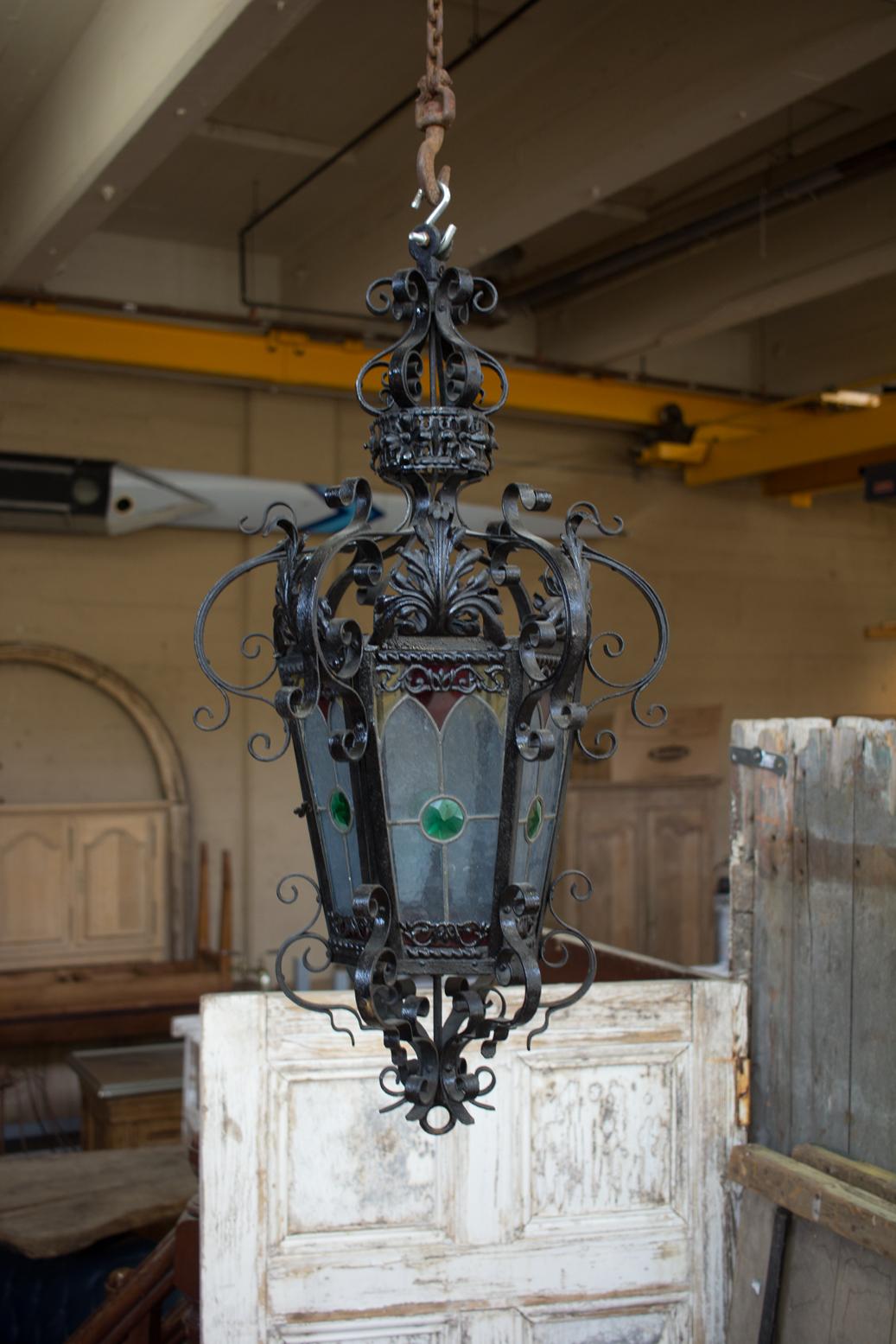 Antique French ornate wrought iron and stained glass lantern.