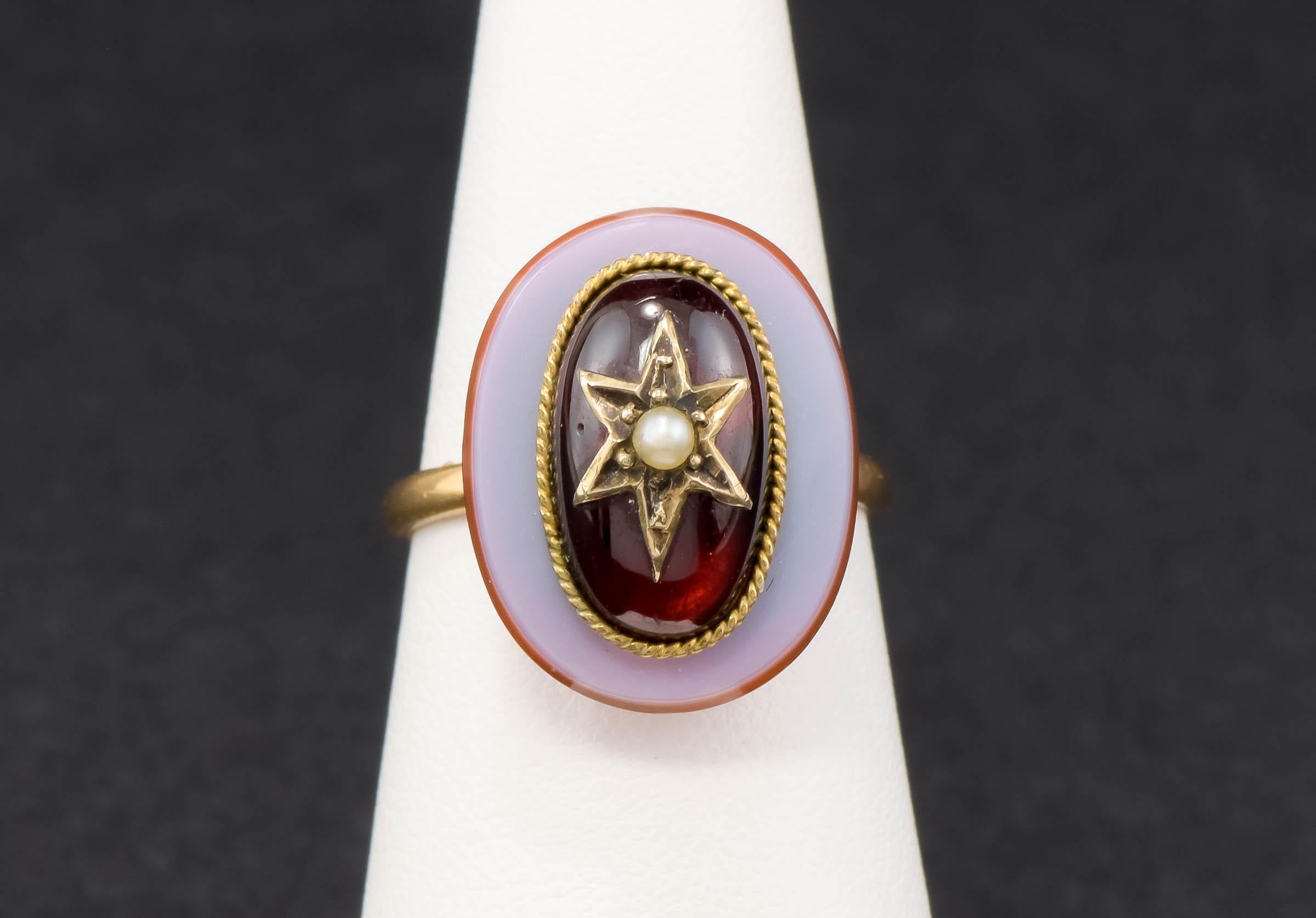 One of a kind and very striking, I found this ring while out antiquing in New England. I love the celestial Star motif and the combination of garnet, agate and pearl. It's definitely an antique conversion ring and remains in very good