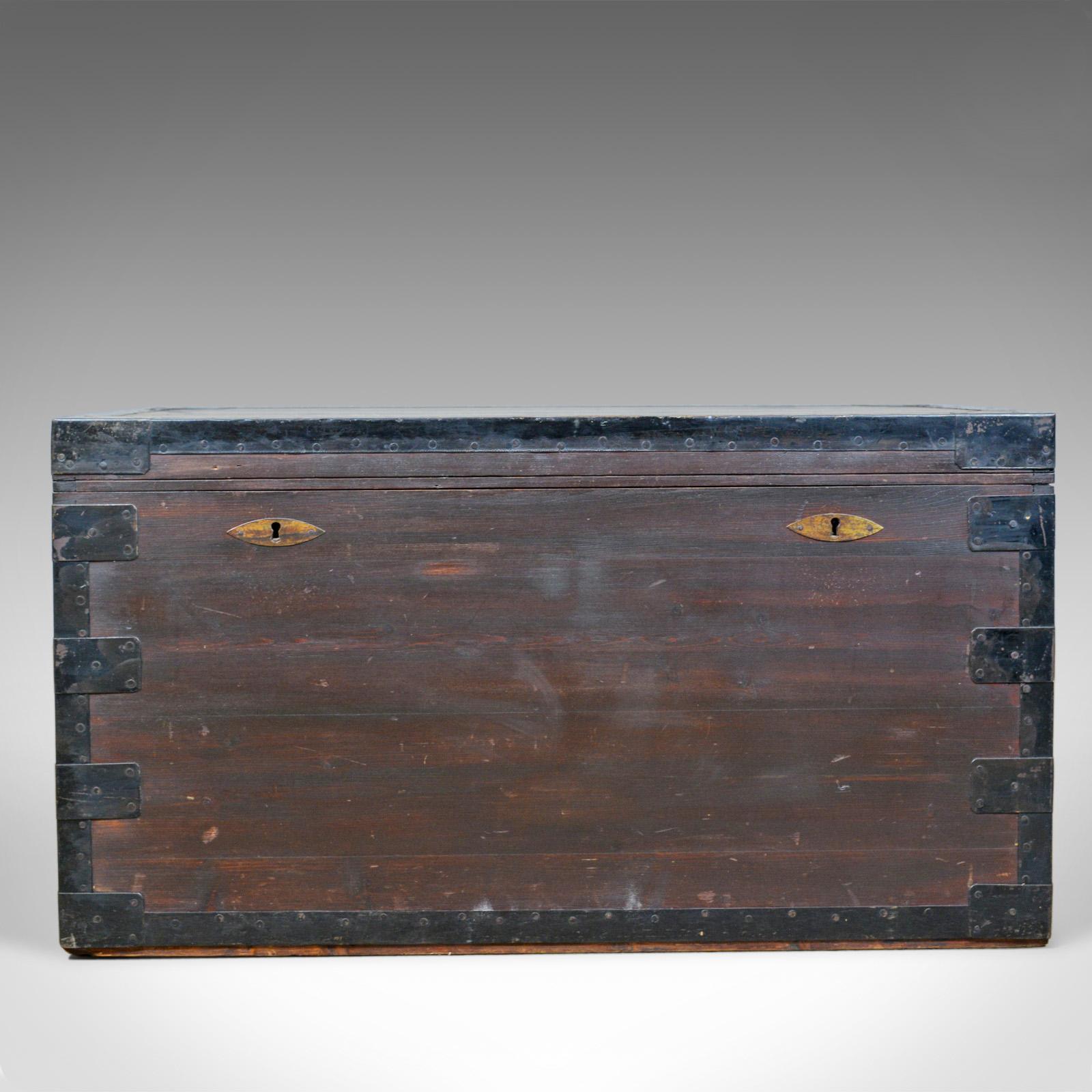 This is an antique steamer trunk of marine interest, an English travel or ship's chest in stained pine and metal lined, dating to the late 19th century, circa 1880.

Robustly constructed in dark stained pine
Grain detail and a desirable aged