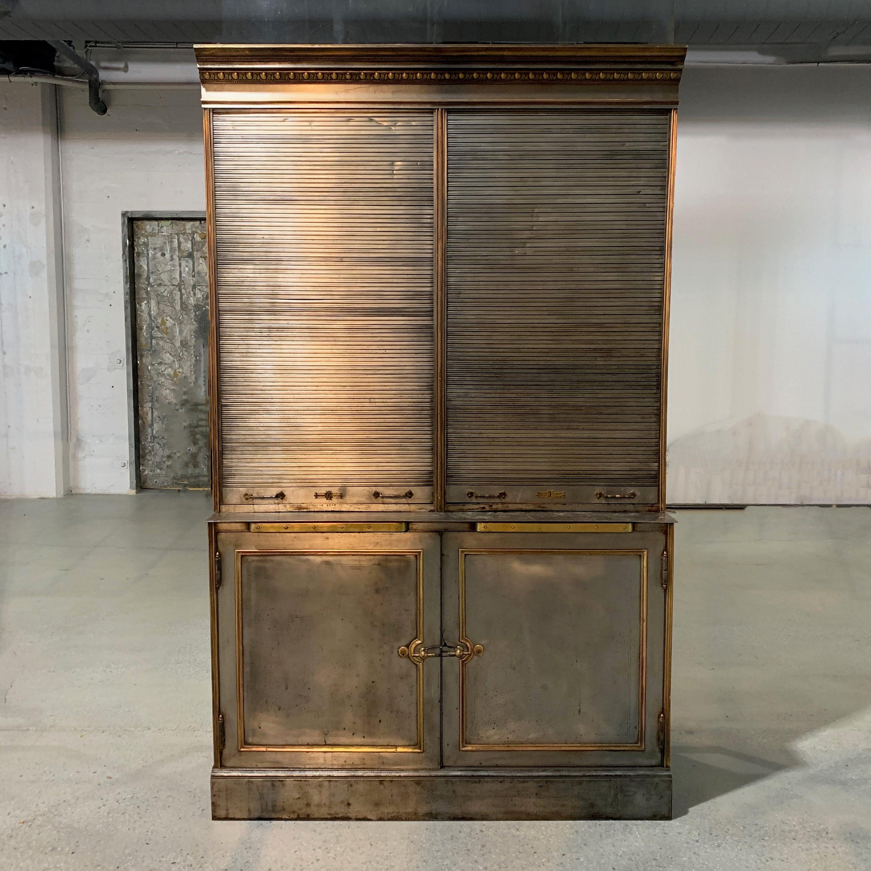 Antique, valuables safe display cabinet is a piece of New York history as it is reputedly from R.H. Macy & Co., Herald Square, circa 1902. The two-piece, steel cabinet features brass filigree details throughout. The 36 inch, counter height bottom