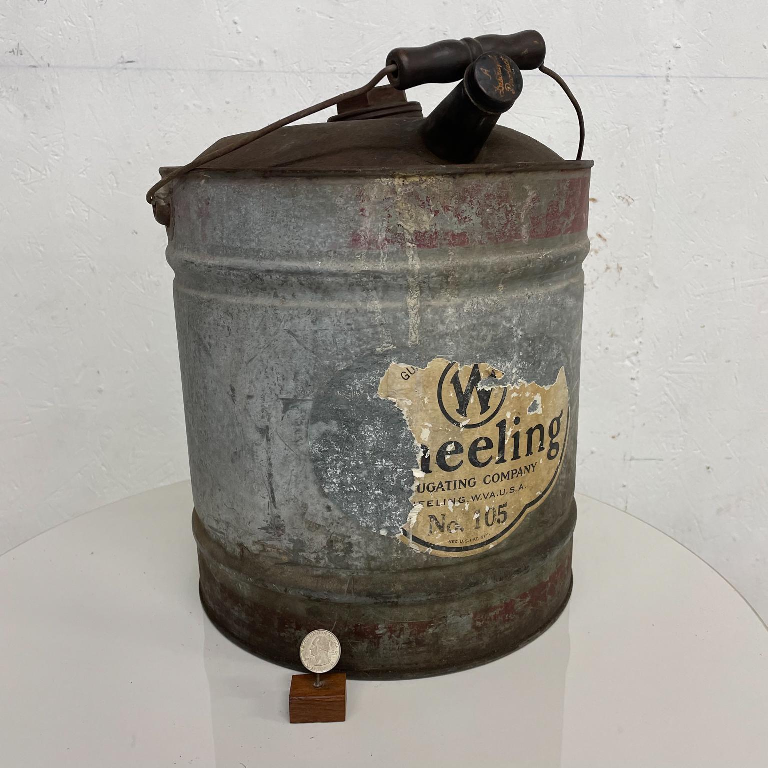 Steel Pour Can
Antique Galvanized steel metal can Funnel spout carry handle 
Historical Wheeling Corrugating Co Wheeling WVA
Measures: 17 tall (top of handle), 14.5 tall x 12 diameter
Galvanized steel vintage can-container with lid and funnel