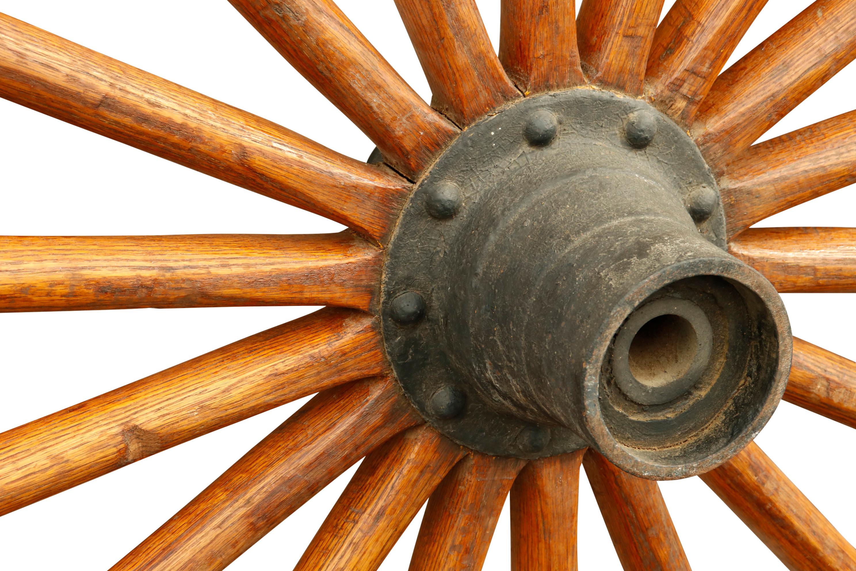 An antique steel and oak wagon wheel with eighteen spokes, two hardwood sectional felloes, a metal hub, and a steel tire. Three steel hooks are welded to the tire so it can be hung. Exceptionally heavy and in great condition.