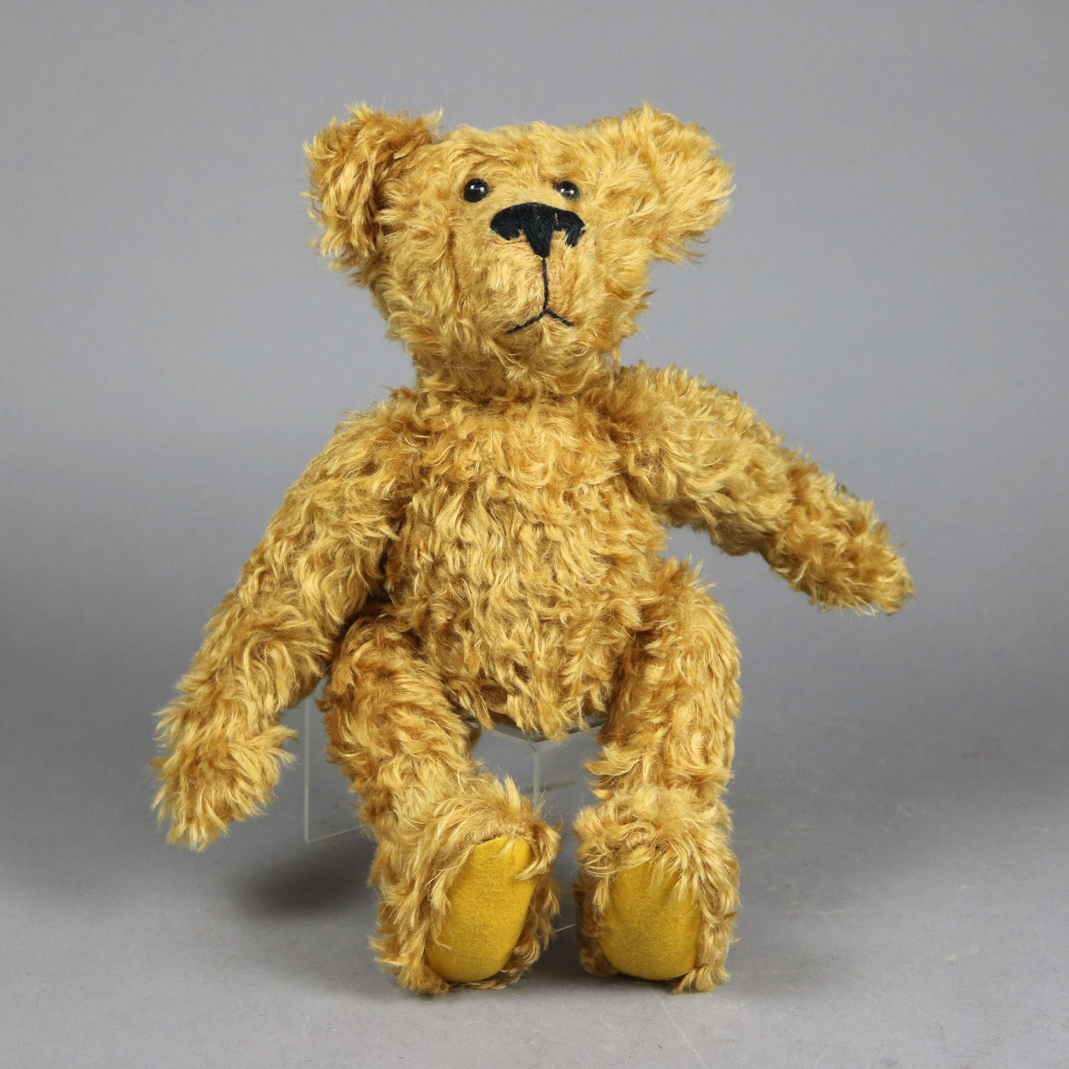 An antique Teddy bear in the manner of Steiff offers standard size with golden coat and jointed limbs, without label, c1940

Measures - 14.5''H x 13.5''W x 5''D.