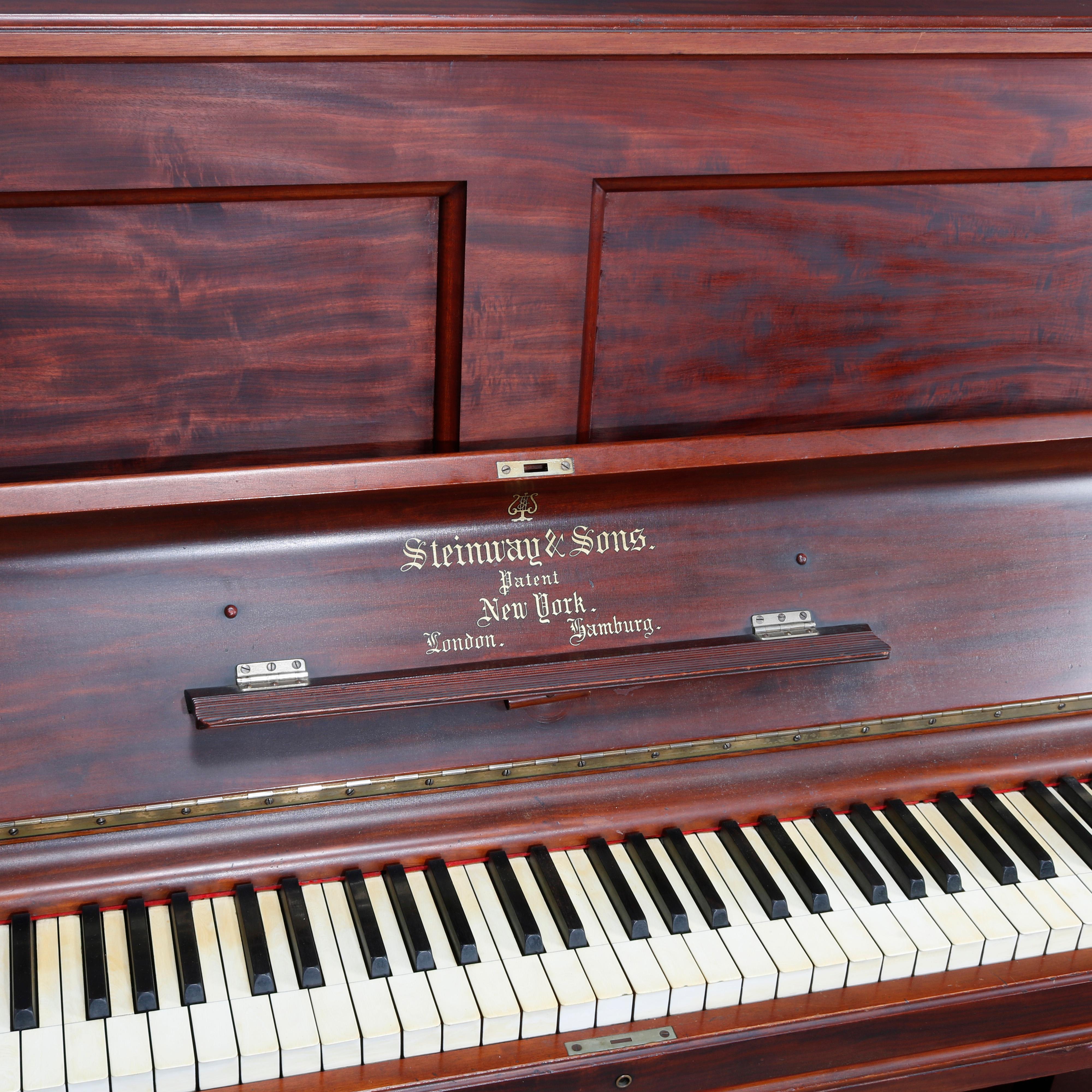 An antique upright grand piano by Steinway & Sons, New York offers a mahogany case with paneled face, balustrade supports, signed with serial #83215 as photographed, good soundboard and working, circa 1864.

Measures: 49.38