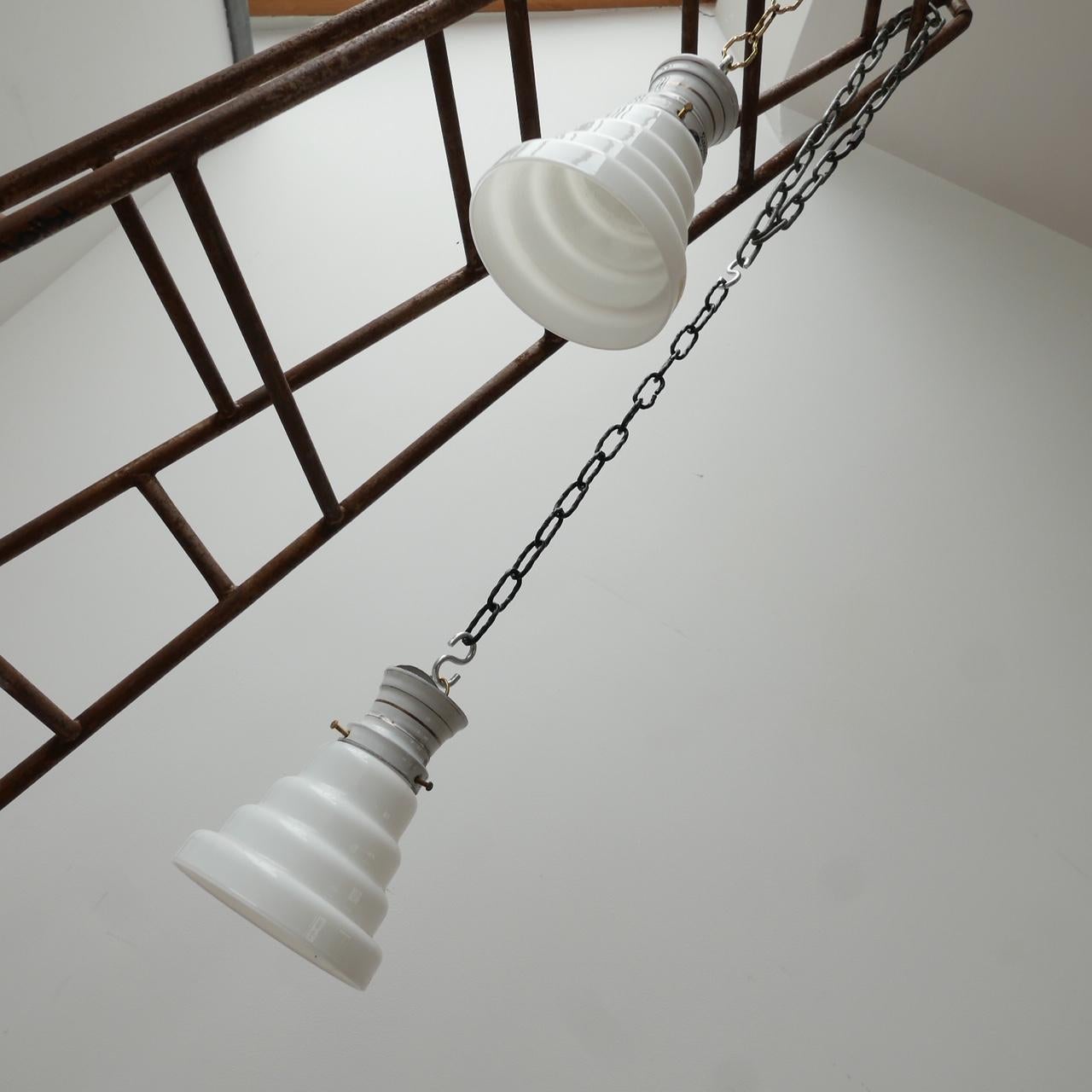 Antique stepped opaline glass pendant lights. 

Sold individually. 

Enamel galleries, opaline glass with open base. 

Germany, c1930s. 

Re-wired and PAT tested. 

Priced and sold individually.

Dimensions: 20 height x 14 diameter in