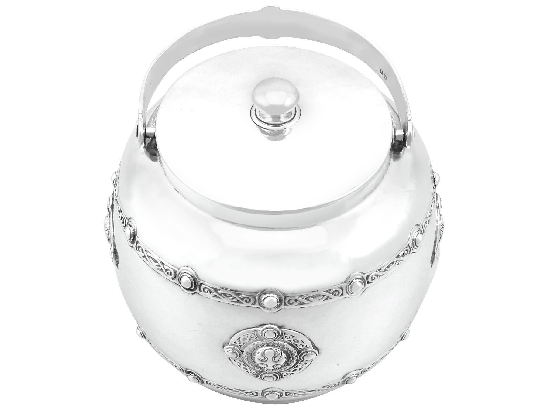 An exceptional, fine and impressive antique George V sterling silver Arts and Crafts style biscuit barrel made by Liberty & Co Ltd; an addition to the ornamental silverware collection

This exceptional, fine and impressive antique George V