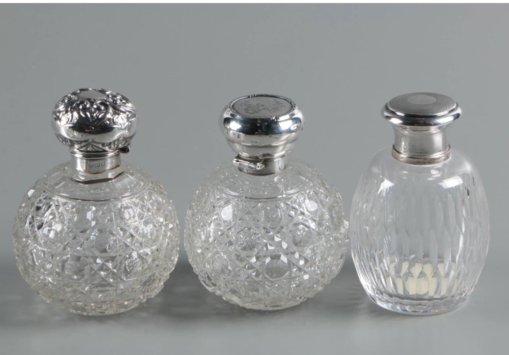 An very important collection of nine (9) antique circa 1839 to 1902 to vintage sterling silver and cut crystal perfume bottle and vanity jars. The collection features a perfume bottle by William Devenport of Birmingham, England, marked with a 1902