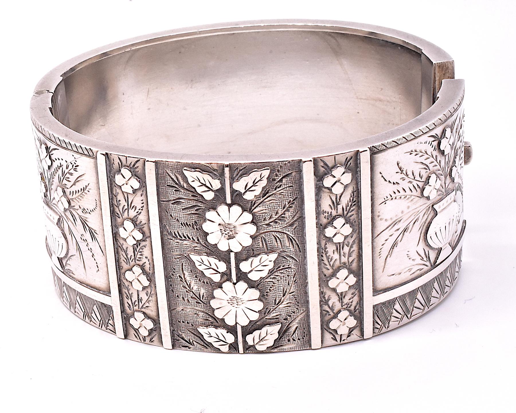 The symbolism and motifs behind the Victorian bangle bracelets, with their quaint floral bouquets and plants and trails of leaves well known. Our Sterling silver bangle has two carved stylized vases of flowers on either side, a vertical array of