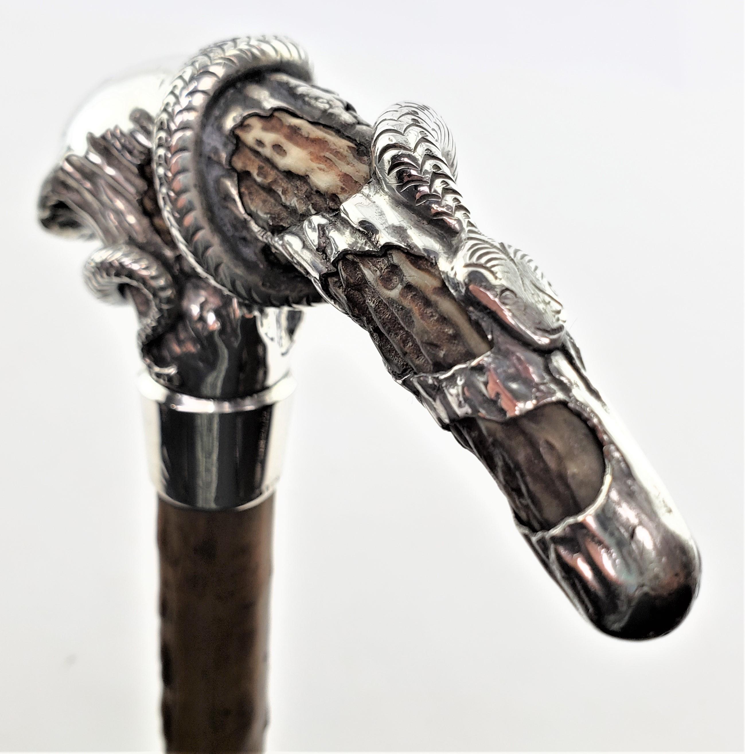 This antique and very well executed sterling silver handled walking stick or cane is unsigned, but presumed to have originated from the United States and dating to approximately 1880 and done in the period Victorian style. The handle of the cane is
