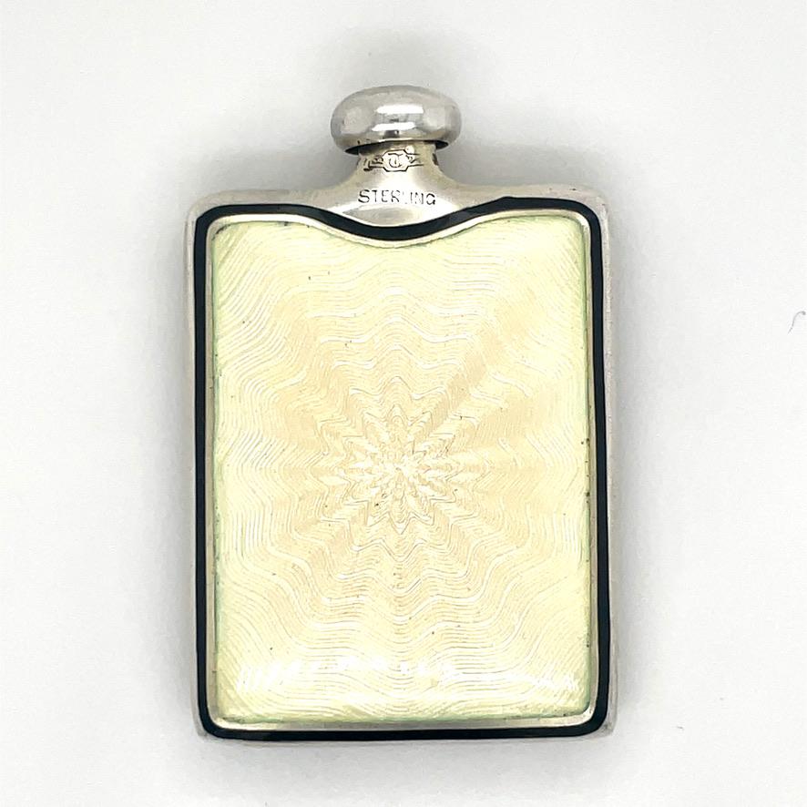 Lovely antique sterling silver purse perfume.  Double-sided iridescent lemon yellow guilloche enamel on front and back, with a black enamel border.  On the front side is a shaded enamel pink flower, with green leaves. The bottle has a long dabber. 1