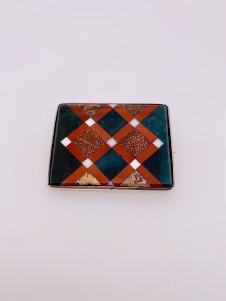 Interesting and unusual Scottish agate pin.  Set in a geometric pattern with intersecting goldstone inlay.  Set in sterling silver.  
1 1/4