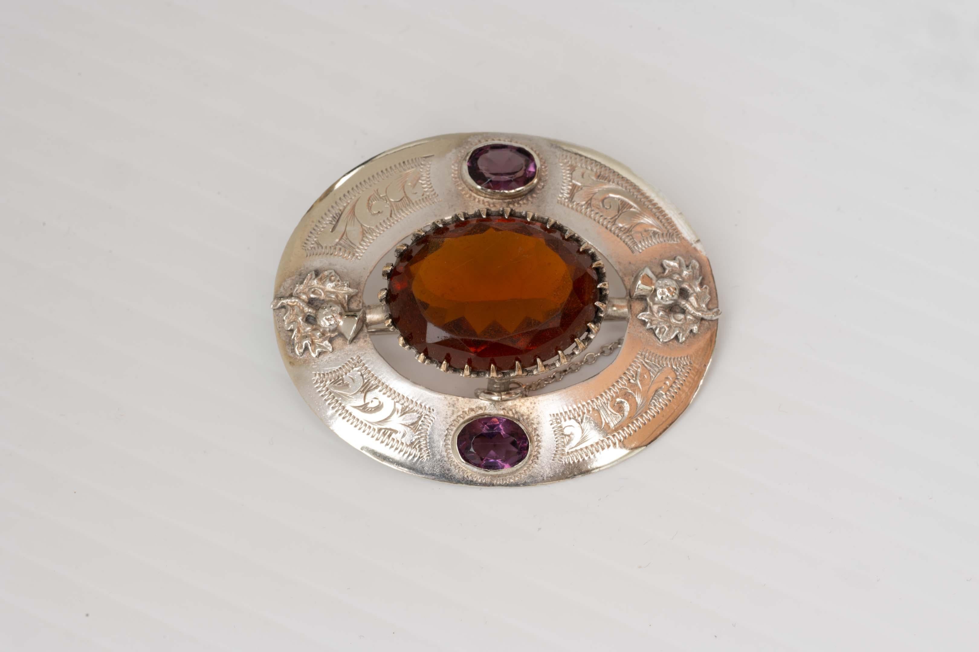 Antique Victorian sterling silver Scottish thistle brooch circa 1870 with amethyst and citrine topaz colour glass stone and thistle design. Not stamped but acid tested. Made in the UK, measures 5cm x 4.1 cm ( 15/8 inches x 2 inches). In good