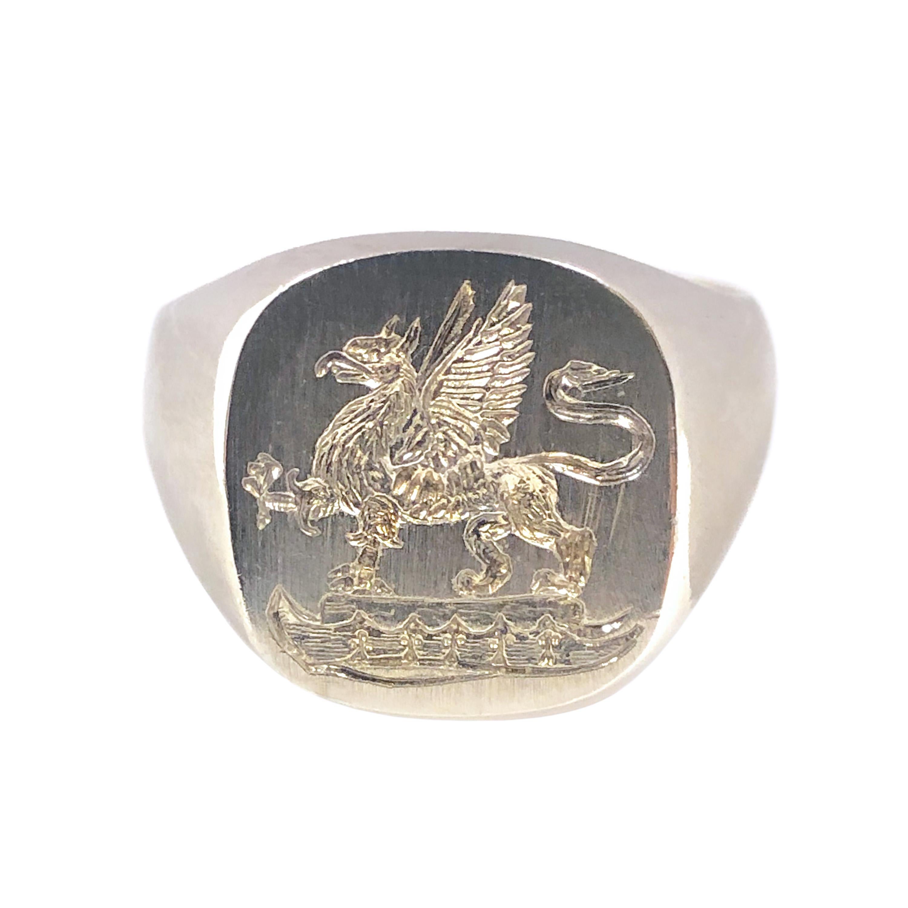 Circa 1920s Sterling Silver Signet Ring, the top measuring 5/8 X 1/2 inch and featuring a deeply carved Signet depiction of a Winged Griffin. Finger size 9.