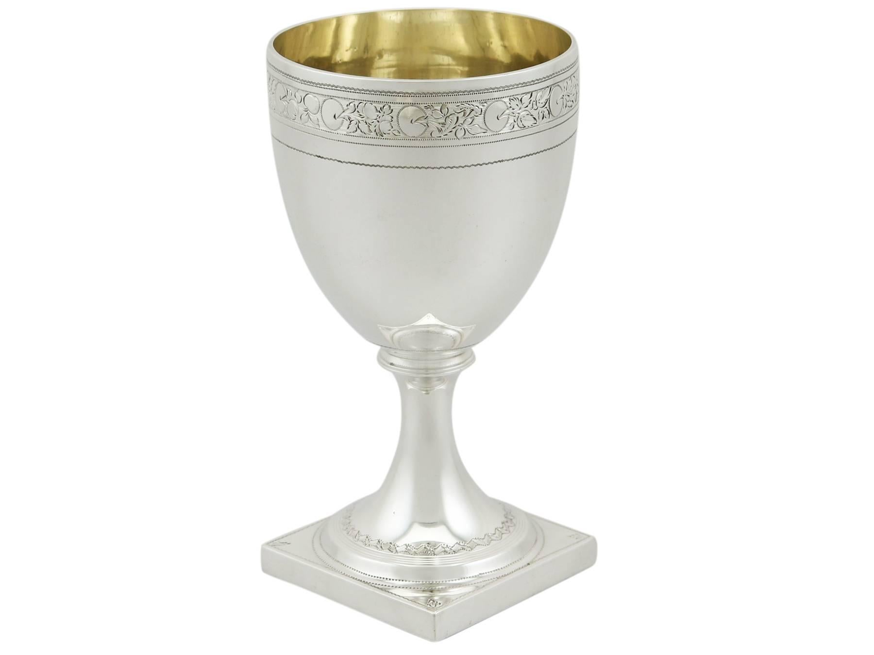 An exceptional, fine and impressive antique George III English sterling silver drinking goblet; an addition to AC Silver's Georgian wine and drinks related silverware collection.

This fine antique Georgian sterling silver drinking goblet has a