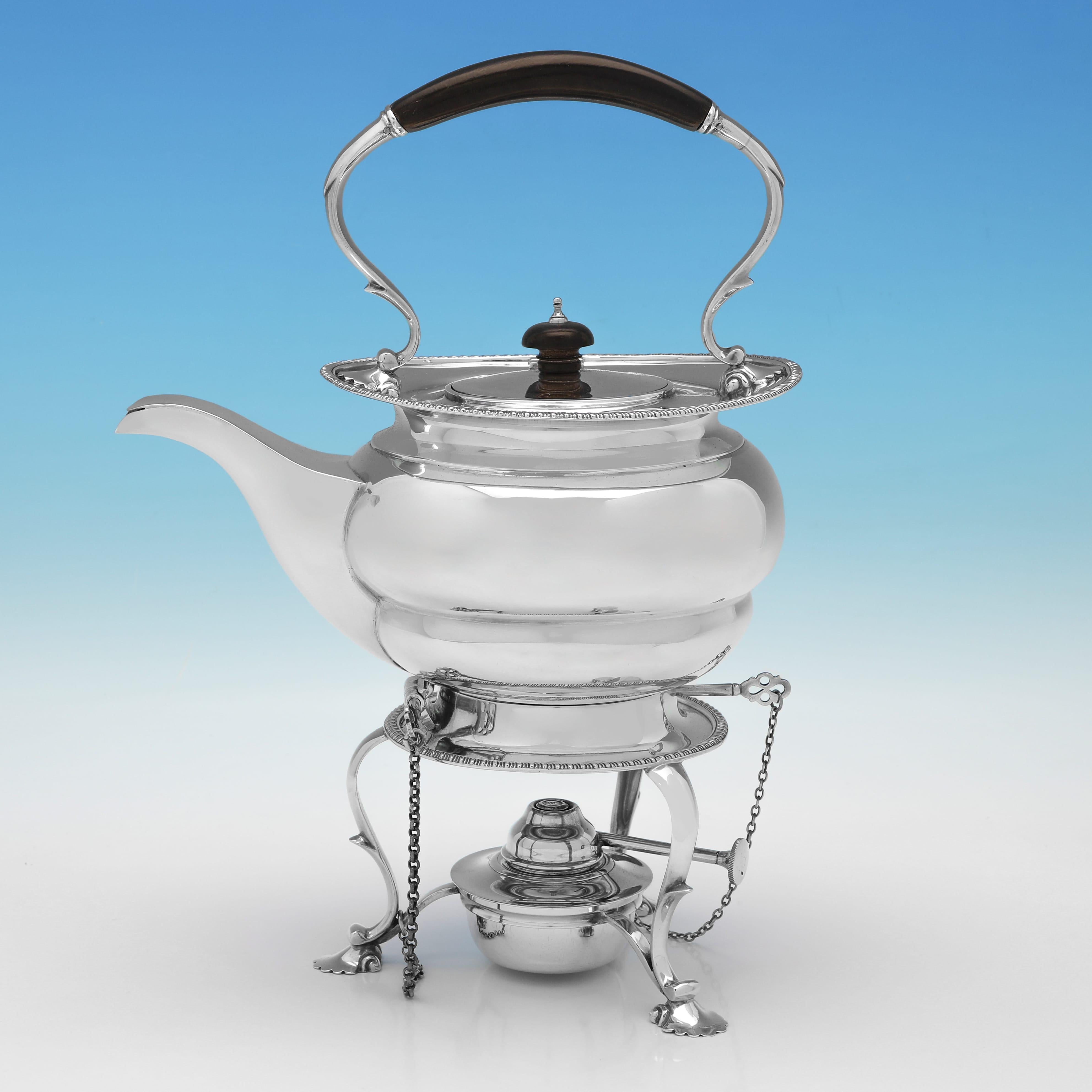 Hallmarked in London in 1922 by Goldsmiths & Silversmiths Co., this handsome, Sterling Silver Tea Set, is plain in style, with gadroon borders to all pieces. 

The kettle measures 12.5