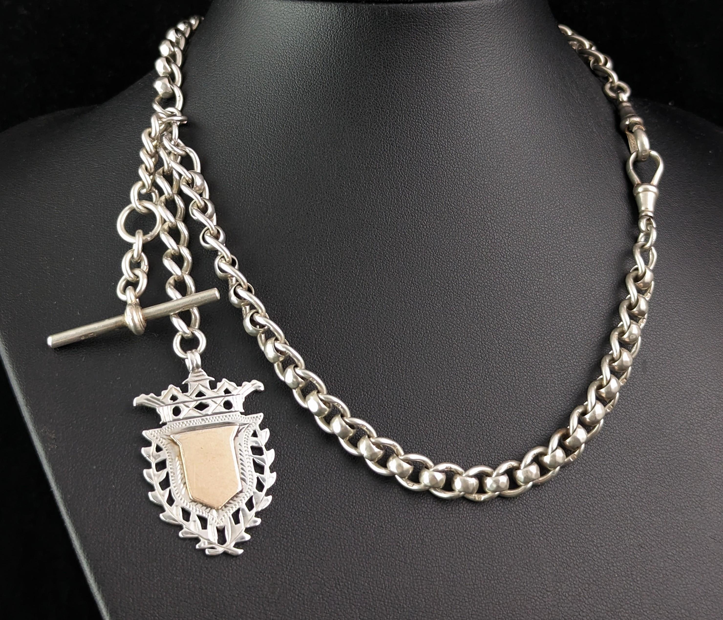 You can't help but fall in love with this handsome antique sterling silver Albert chain.

It features a fancy link chain with interlocking rolo and open curb links, a substantial chain, it features a gorgeous sterling silver shield shaped fob which