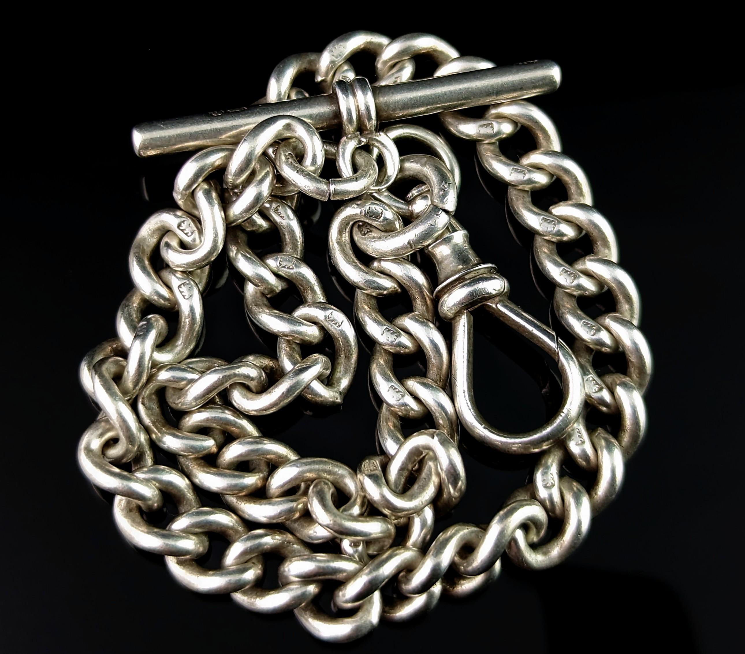 A charming staple for any pocket watch lover, a gorgeous antique sterling silver Albert chain.

This is a sterling silver chain with a chunky graduating curb link with a dog clip fastener to one end and a t bar to the other.

Each link is stamped
