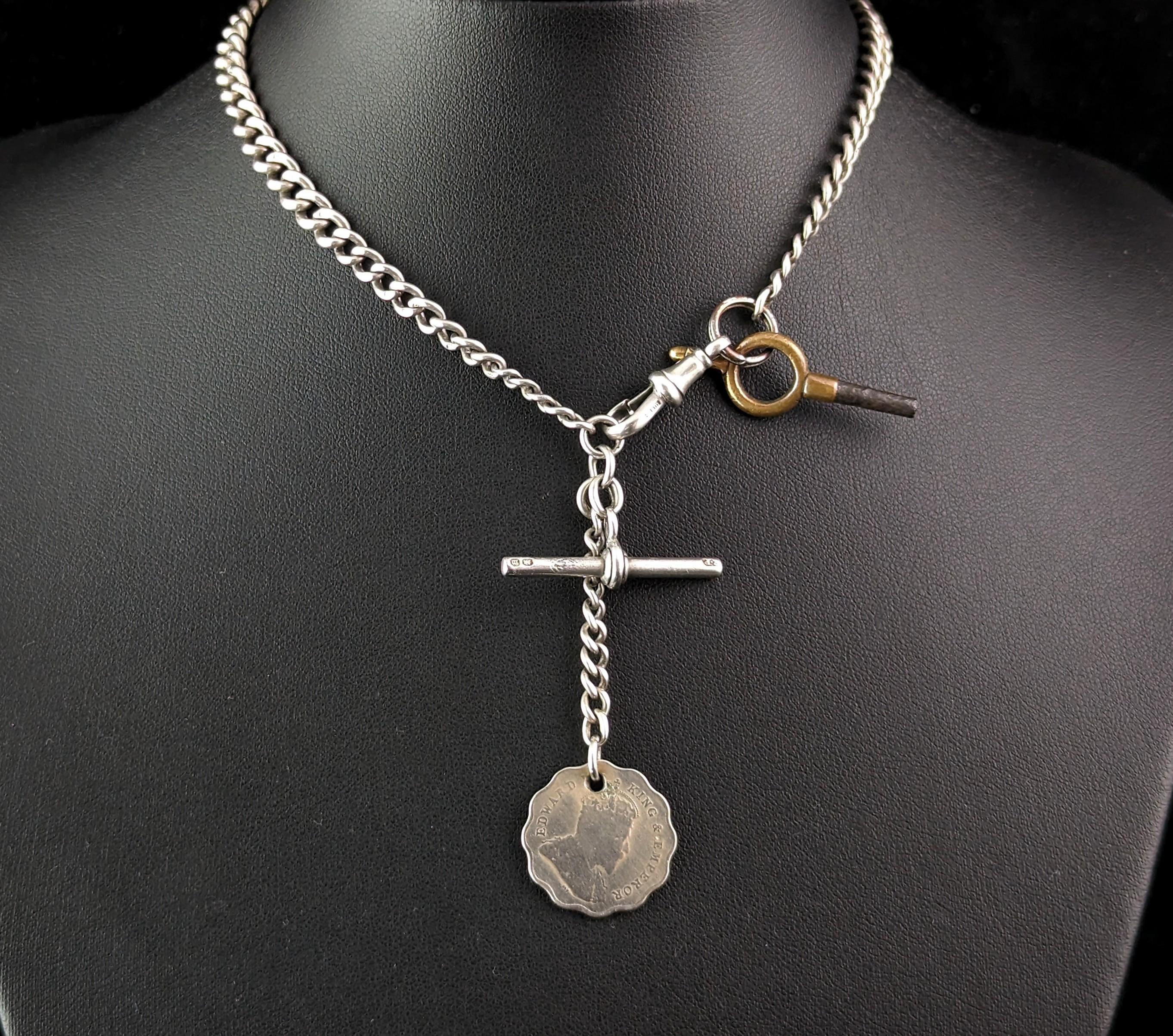 An attractive antique, Edwardian era sterling silver Albert chain or watch chain.

Nice solid silver, graduated curb links with a dog clip fastener to one end with an Edwardian coin fob and pocket watch key attached.

The chain is made from sterling