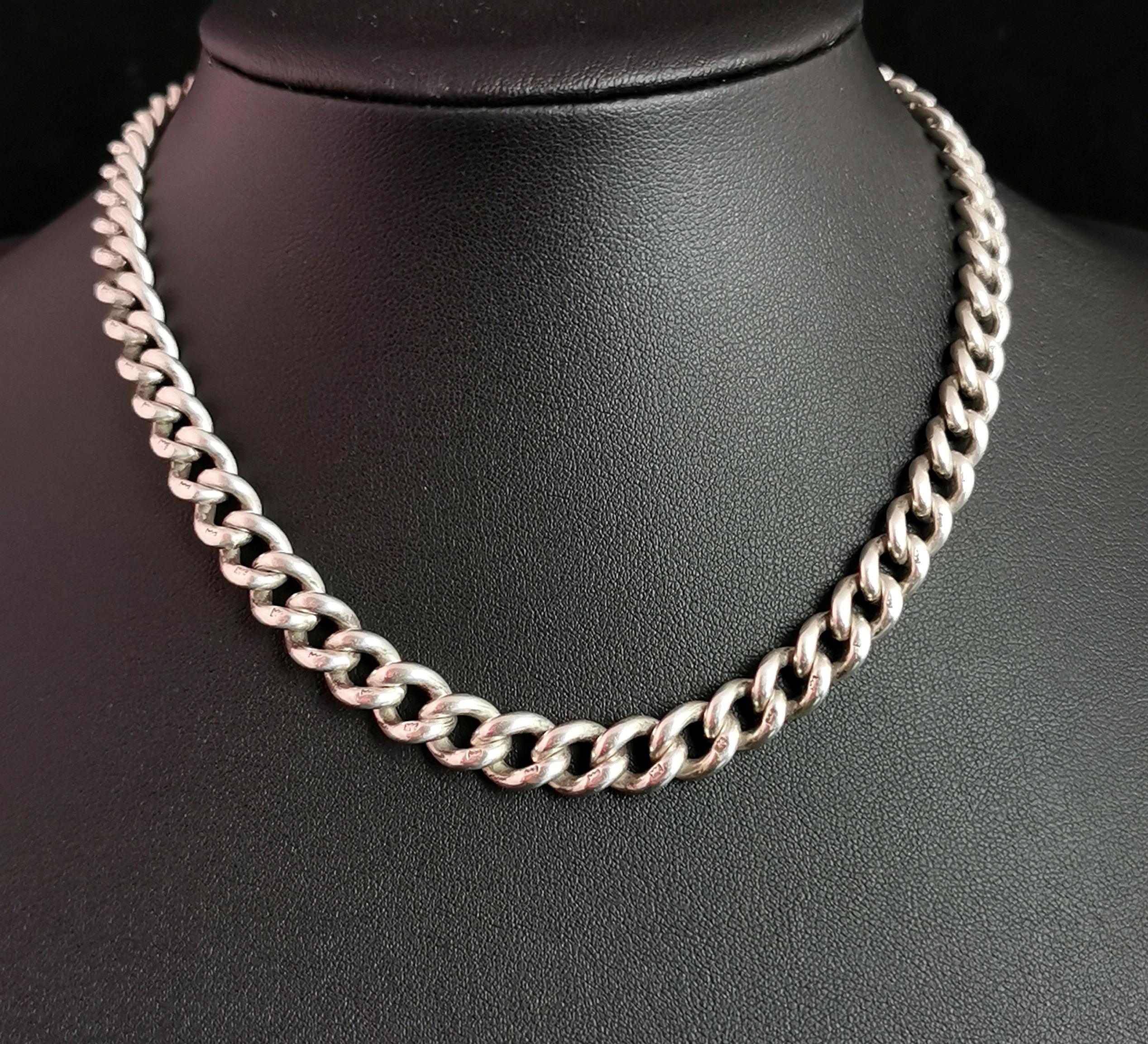 An attractive antique, Victorian era sterling silver Albert chain or watch chain.

Nice chunky silver, graduated curb links with a dog clip fastener to one end and a brass t bar to the other.

The chain is made from sterling silver and each link is