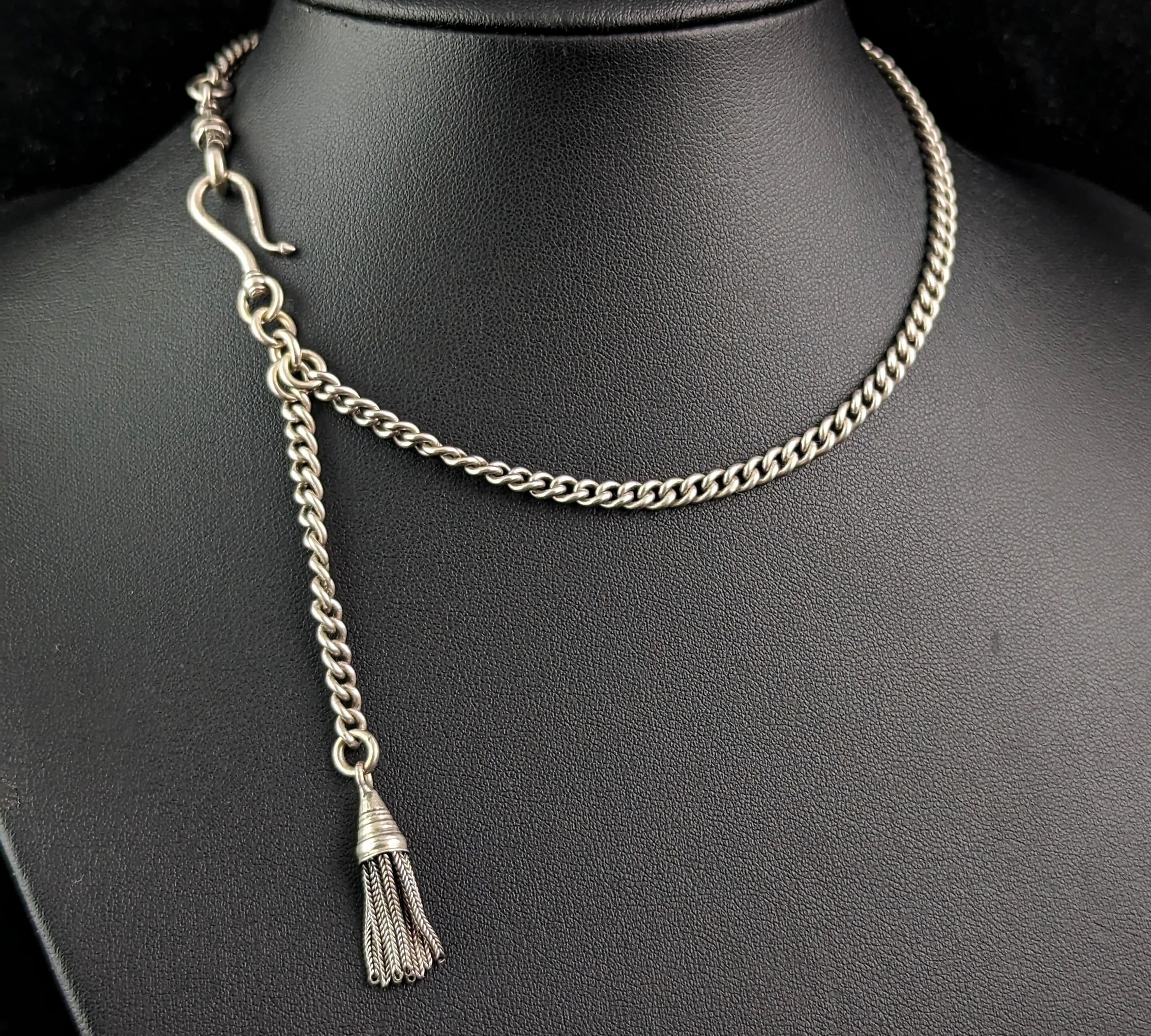 A most beautiful antique, Victorian era ladies chatelaine style Albertina or watch chain.

The chain is a slender, slightly graduated curb link much like an Albert chain and it has a small silver chatelaine hook and a dog clip fastener, it has a