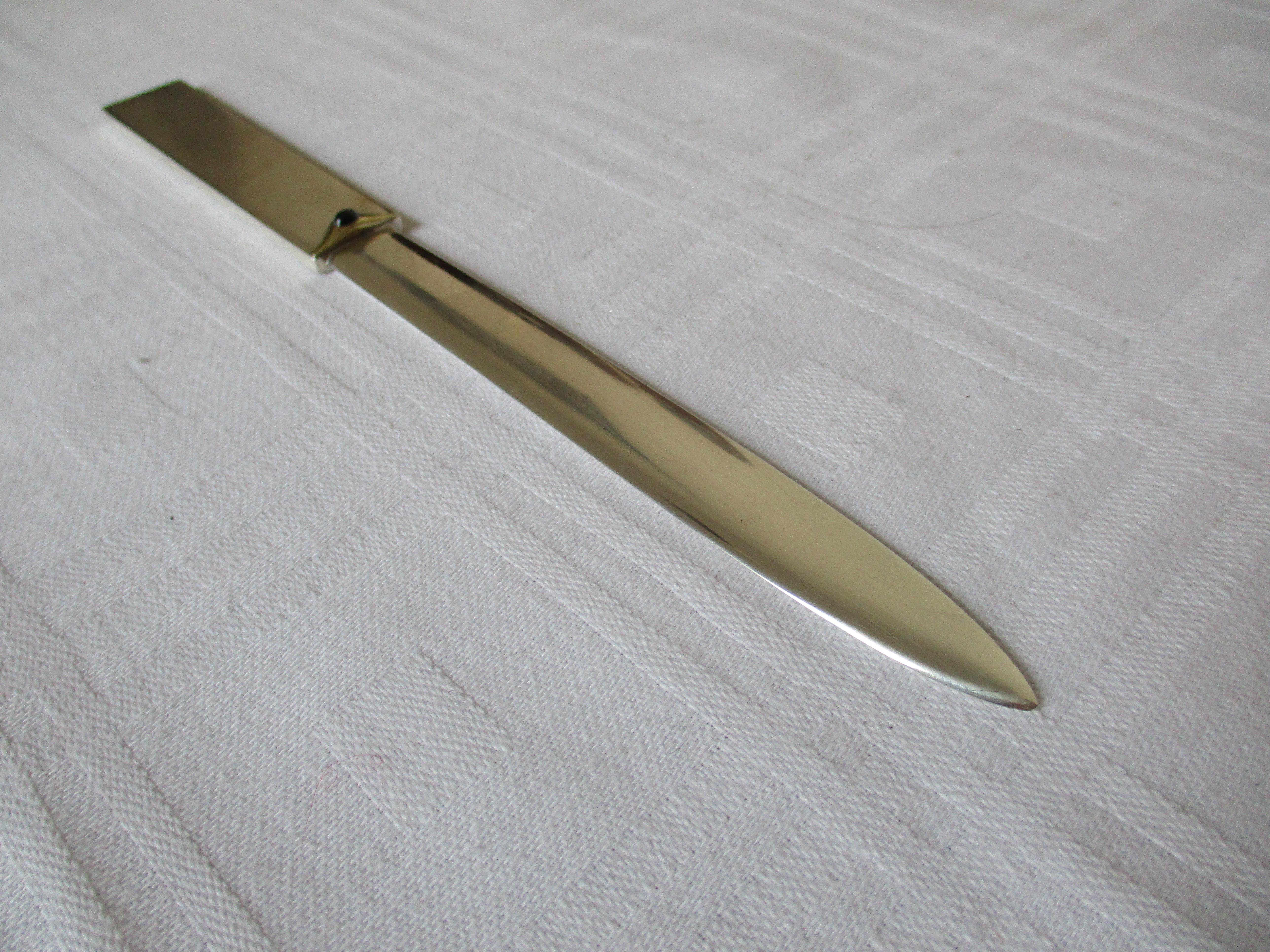 Beautiful letter opener in Sterling Silver 925, 14k applicated gold and a small sapphire in the middle between the blade and the handle. Marked EB.