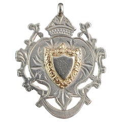 Antique sterling silver and 9k gold shield fob pendant 