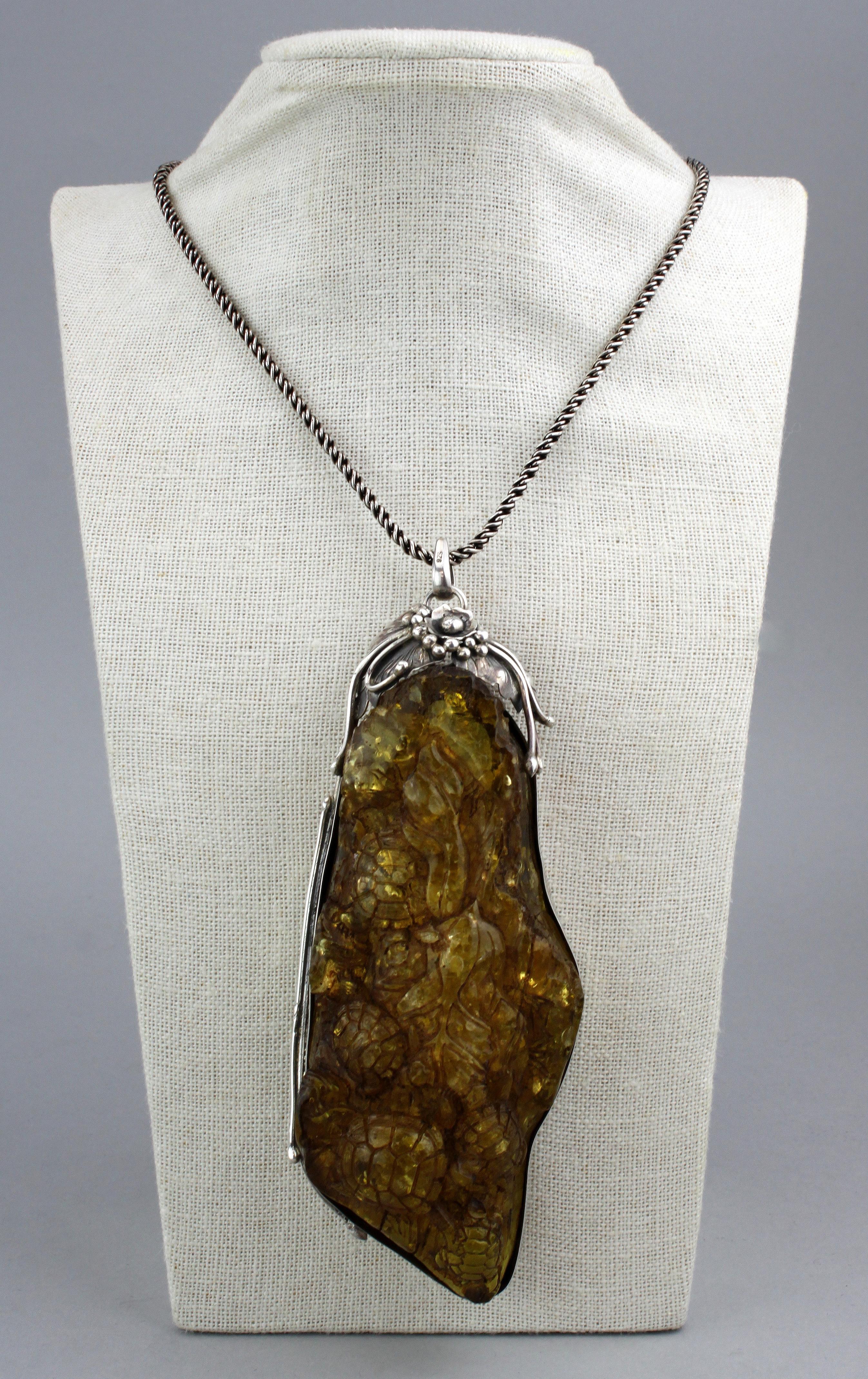 Antique sterling silver and amber carving pendant necklace, from St Petersburg, Russia.
Hallmarked 925
Made in Russia, St. Petersburg 1892.
Stamped St. Petersburg 1892.

Dimensions -
Length : 79.5 cm
Necklace Width : 0.4 cm
Pendant / Carving Size :