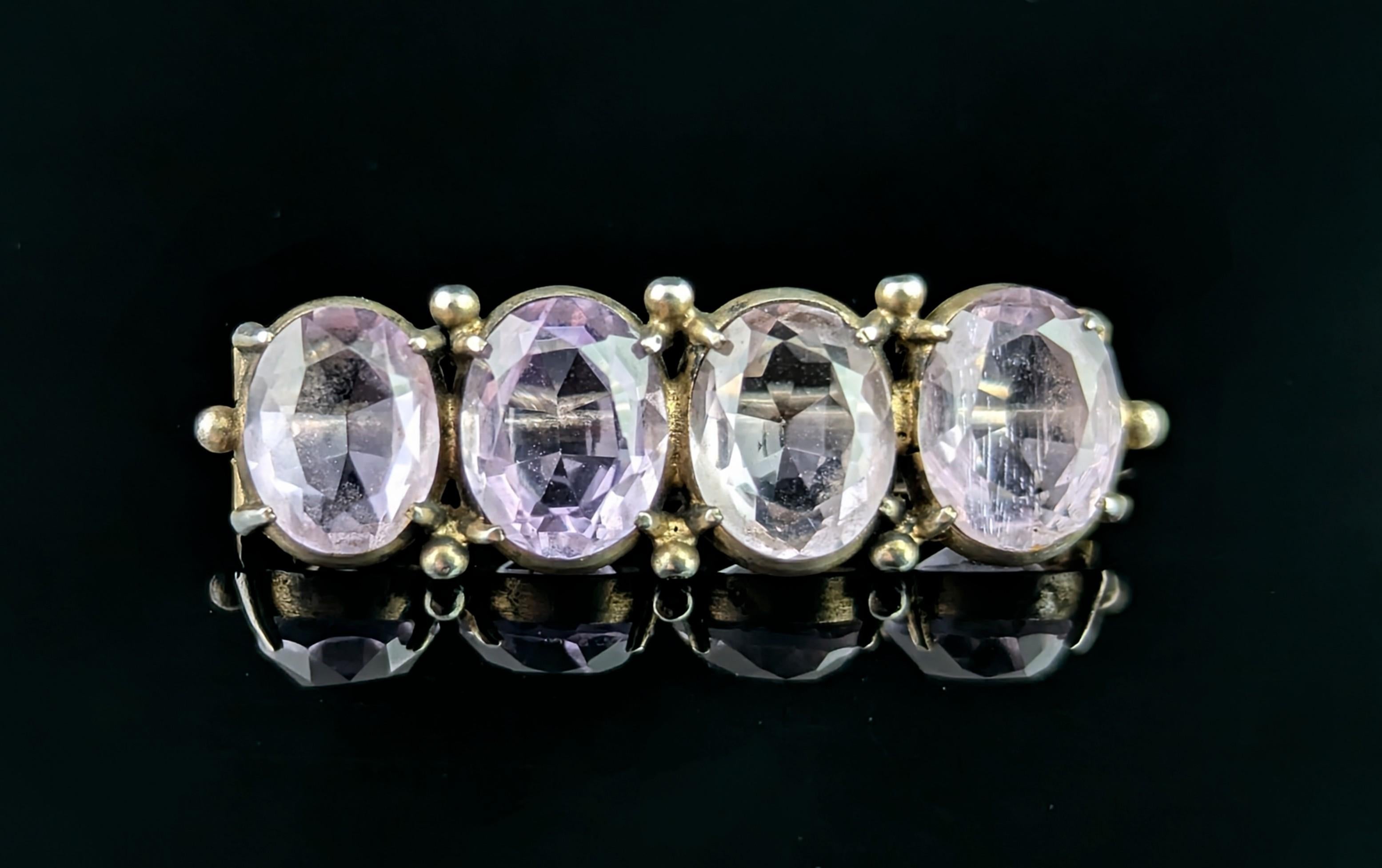 A pretty little antique sterling silver and Amethyst brooch.

This sweet brooch features four oval cut Amethyst stones in a lovely light purple hue.

There is a little beaded detailing running along the top and bottom of the brooch, it appears to