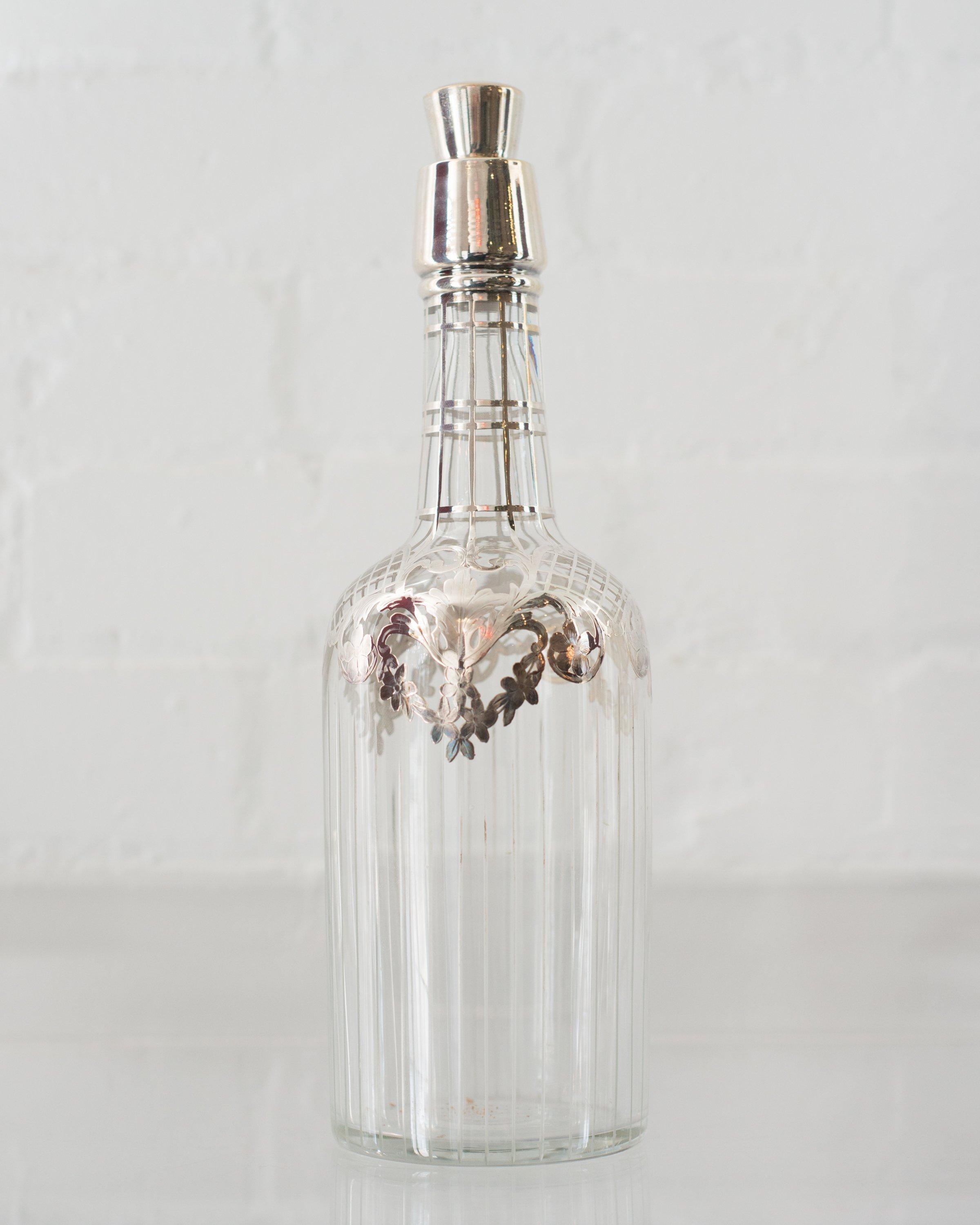 This antique sterling silver and crystal decanter was originally used for wine or spirits. What makes it so special is the delicate lattice work of silver that decorates the glass, with matching cork and silver stopper. Both the glass and the