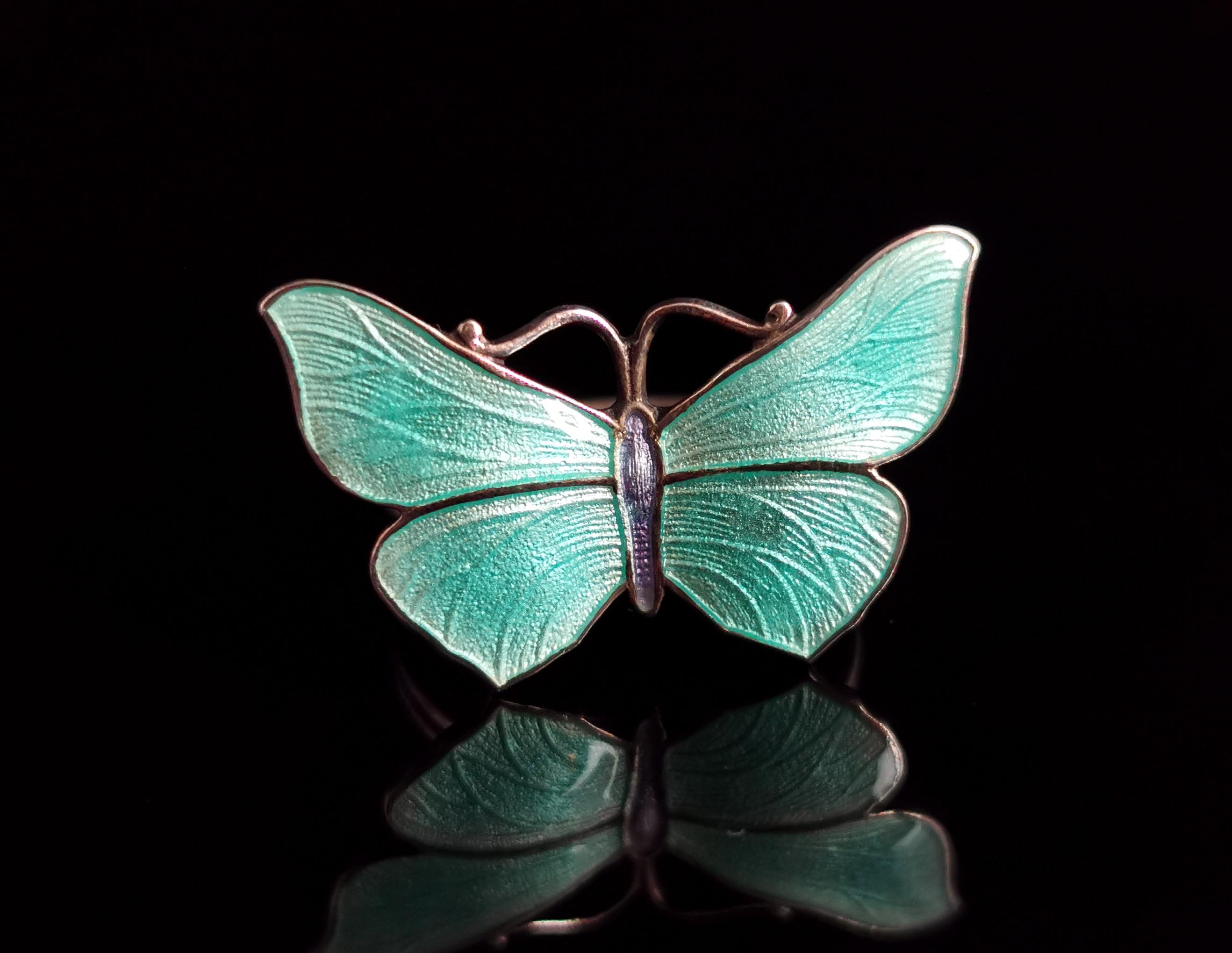 A very beautiful antique Art Deco era sterling silver and guilloche enamel butterfly ring.

So much detailing on this pretty piece, the face is designed as a butterfly with open wings with a beautiful blue guilloche enamel finish which exhibits