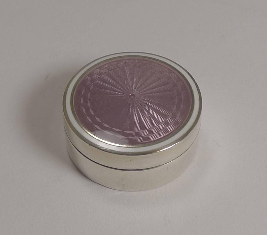 A pretty little continental pill box made in 935 silver which leads it's origin to perhaps Austria or Switzerland. It is stamped 935 and there is a small maker mark, hard to identify.

The slightly domed lid is covered in the prettiest lilac