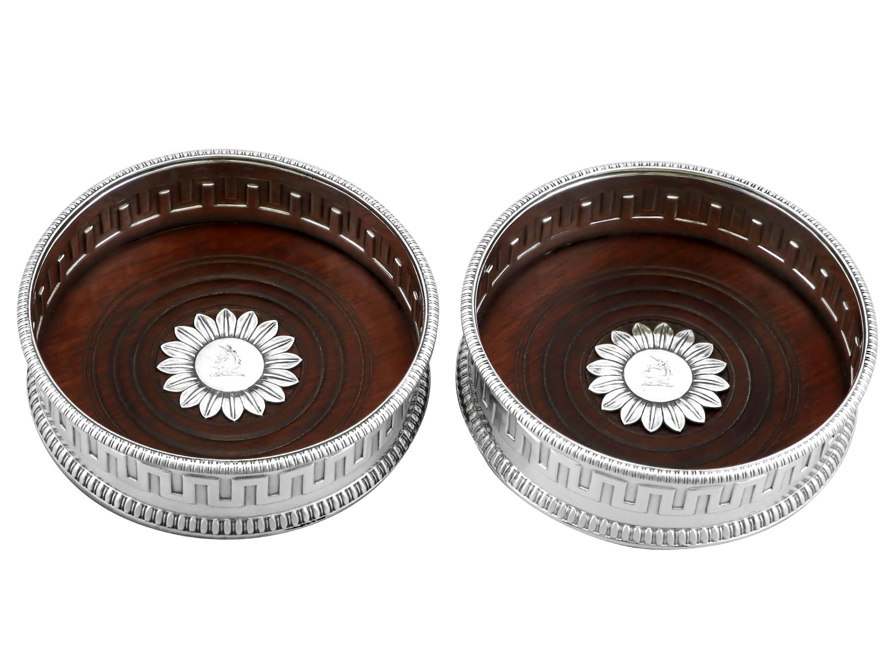 An exceptional, fine and impressive pair of antique English sterling silver coasters; part of our silver wine related collection.

These exceptional antique sterling silver coasters have a circular rounded form.

Each coaster is encompassed with an