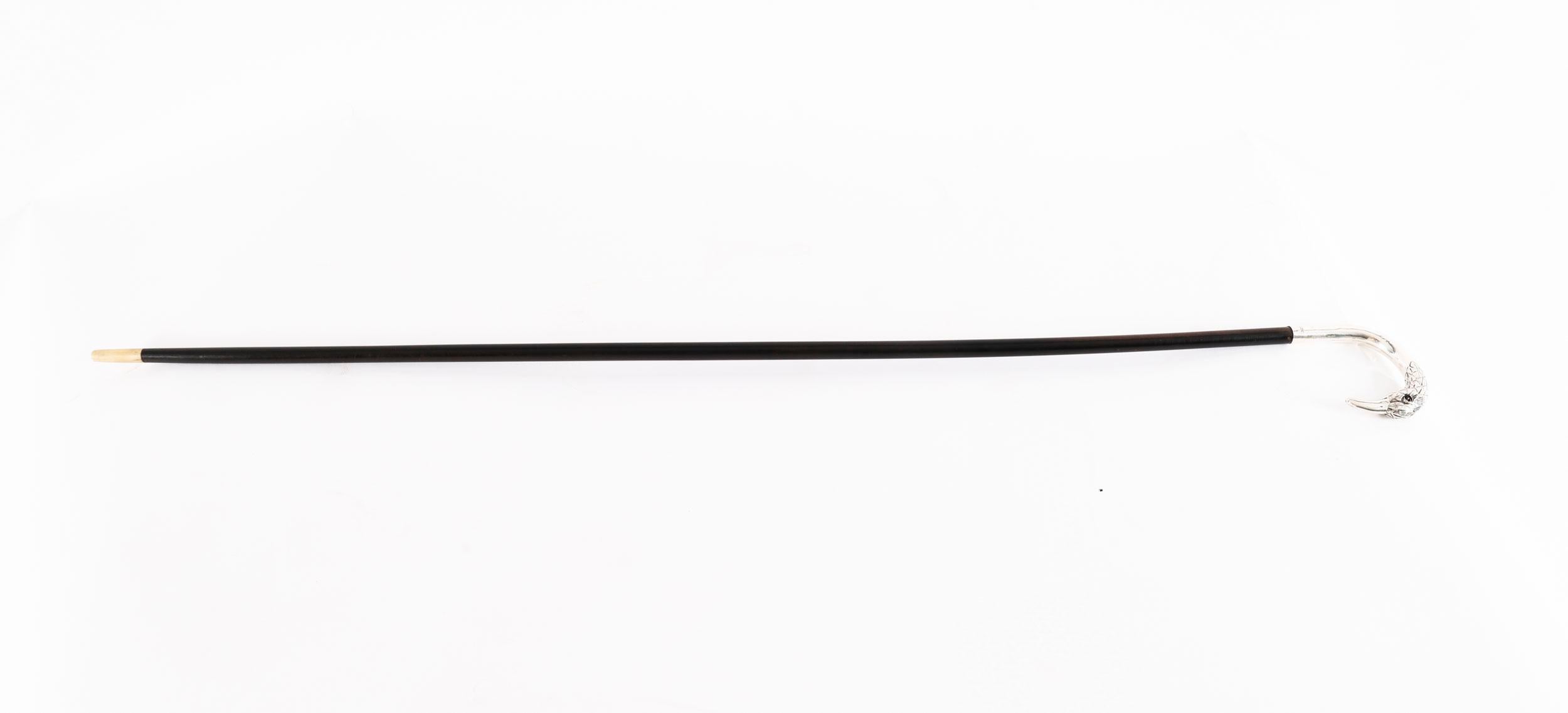 This is a beautiful antique sterling silver bird's head handle ladie's walking cane bearing silver hallmarks for London 1914.

The silver handle features a crook handle modelled as a bird with long beak and inset glass eyes on a stained tapering