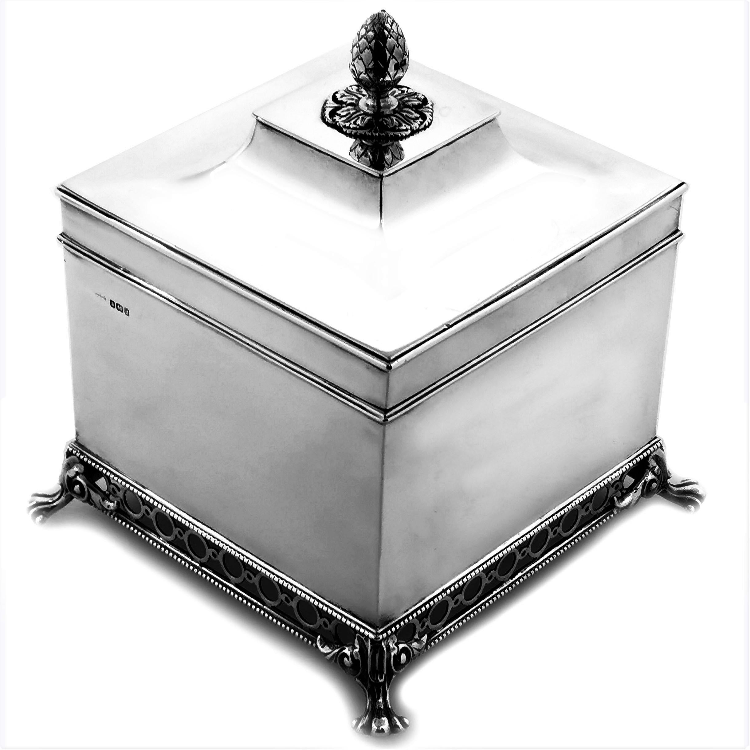 A lovely Antique sterling silver box with a square shape and a elegantly sloped concave lid. This Silver Box has a highly polished finish. The Box has an impressive finial and stands on a pierced border supported by four claw feet.

Made in 1912