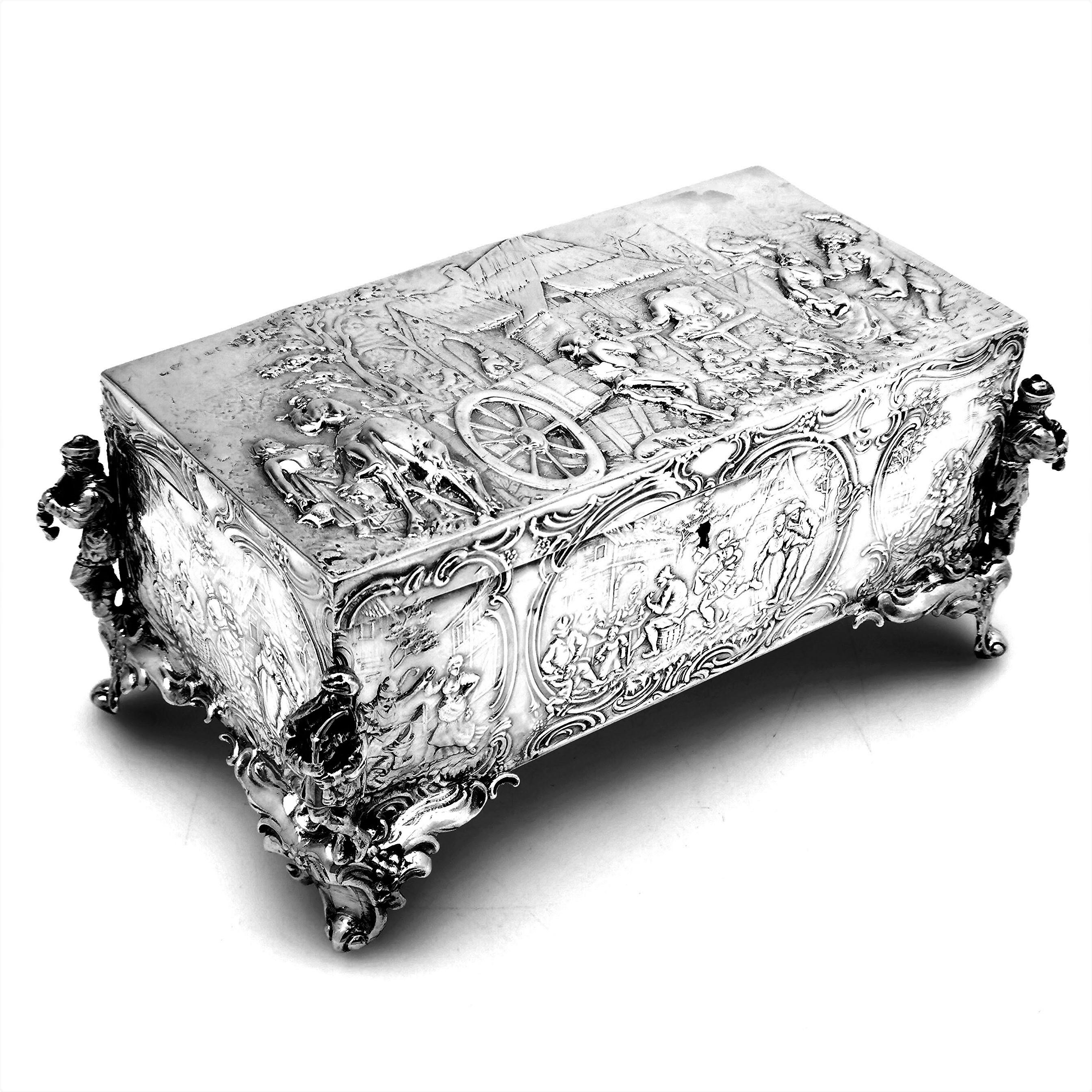 A lovely antique German silver Jewellery Box featuring beautiful chased designs on the lid and sides. The Box stands on four figural feet and is lightly gilded on the inside.

Made in Germany by Berthold Muller. English Import Marks for